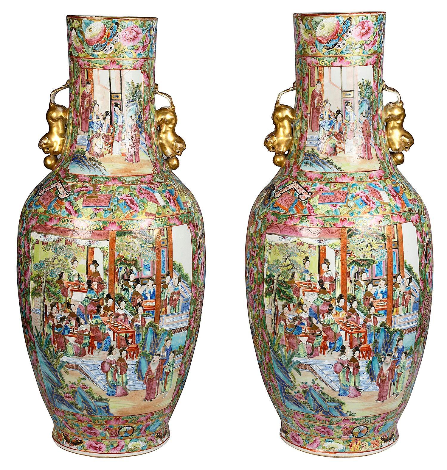 A very good quality pair of 19th Century Chinese Canton / Rose medallion vases / lamps. Each with wonderful bold classical greens and pinks, pairs of gilded Foo dog handles. The ground with the traditional floral and motif decoration, inset hand