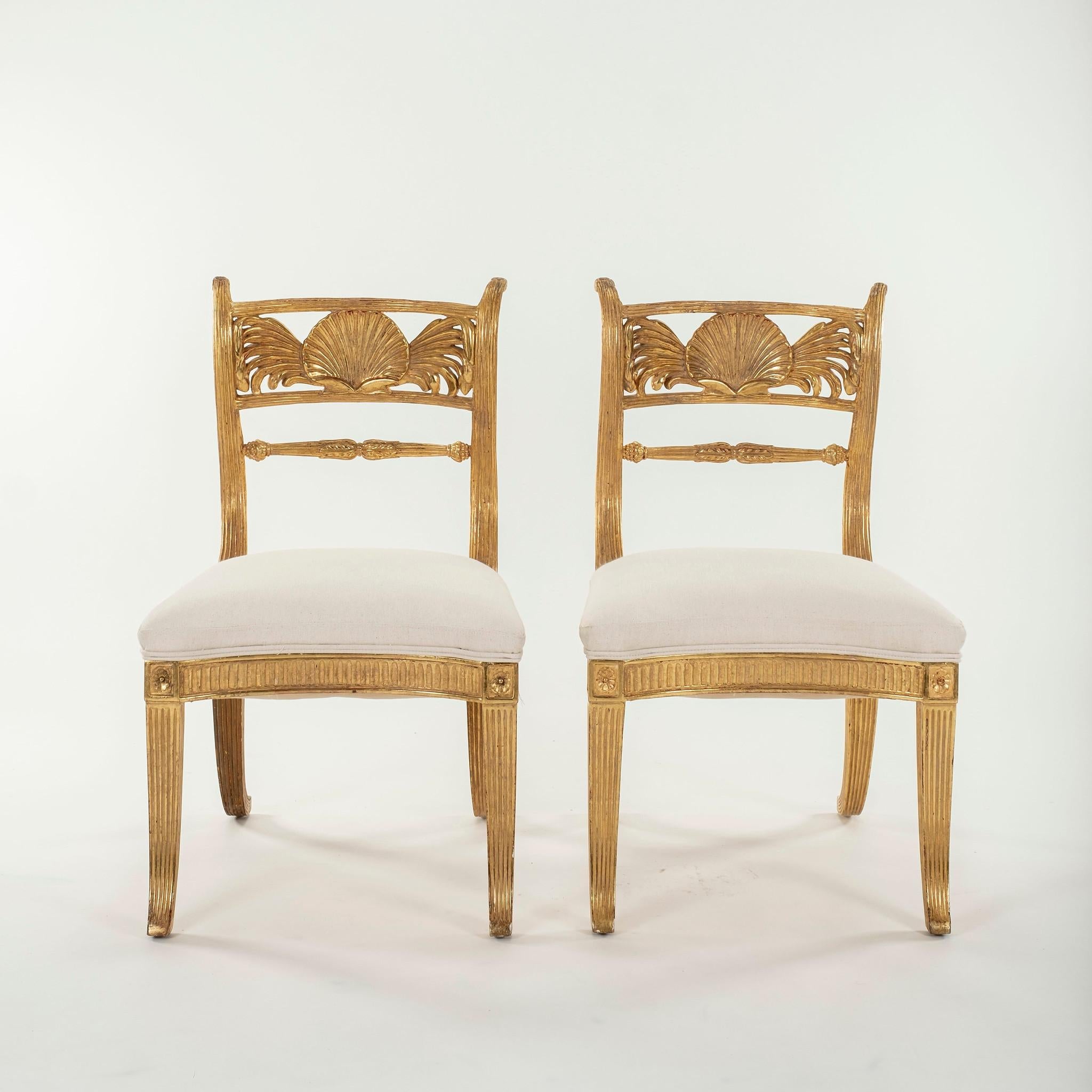 A pair of stylish Rose Tarlow Regency style shell back chairs finished in 22K gold.