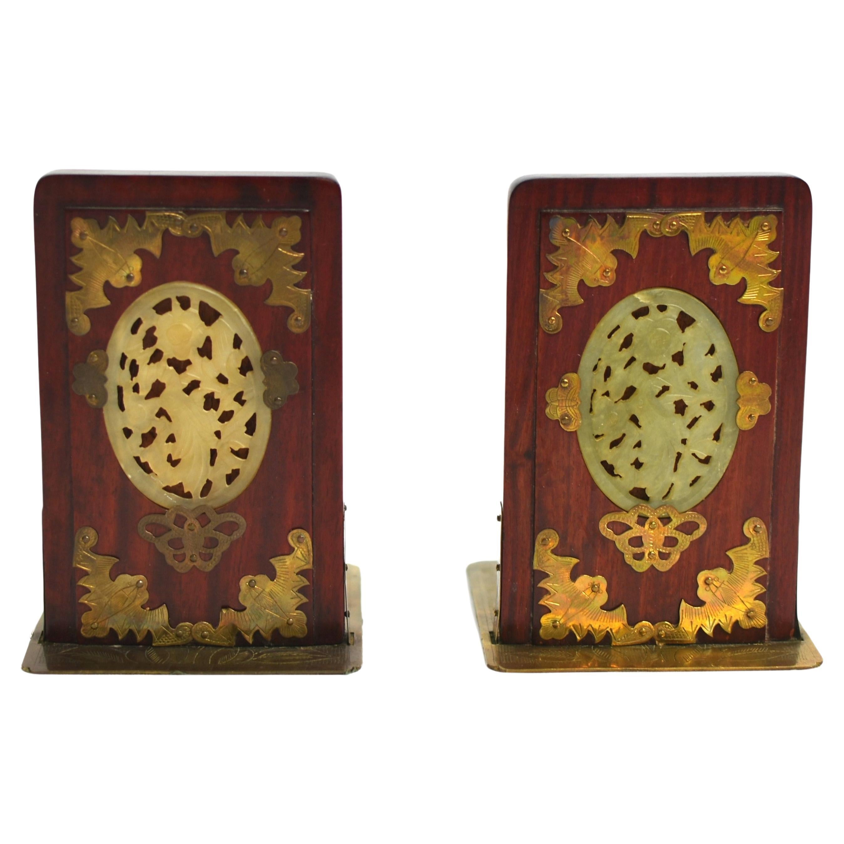 From a private collection, a pair of spectacular solid Rosewood bookends. The featured oval medallion in carved jade depicting birds and flowers is secured by a trio of brass butterflies, all surrounded in four corners by good fortune bats.