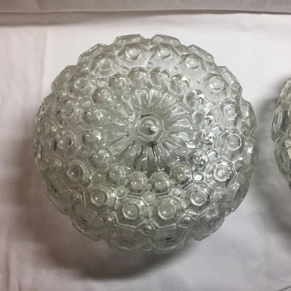 A lovely pair of round 1960s pimples glass flush mount or sconces. The pimple glass gives these a great bubble glass effect. Each fixture requires one European E26 / E27 Edison bulbs, each bulb up to 40 watts. Rewired to meet U.S. standards.