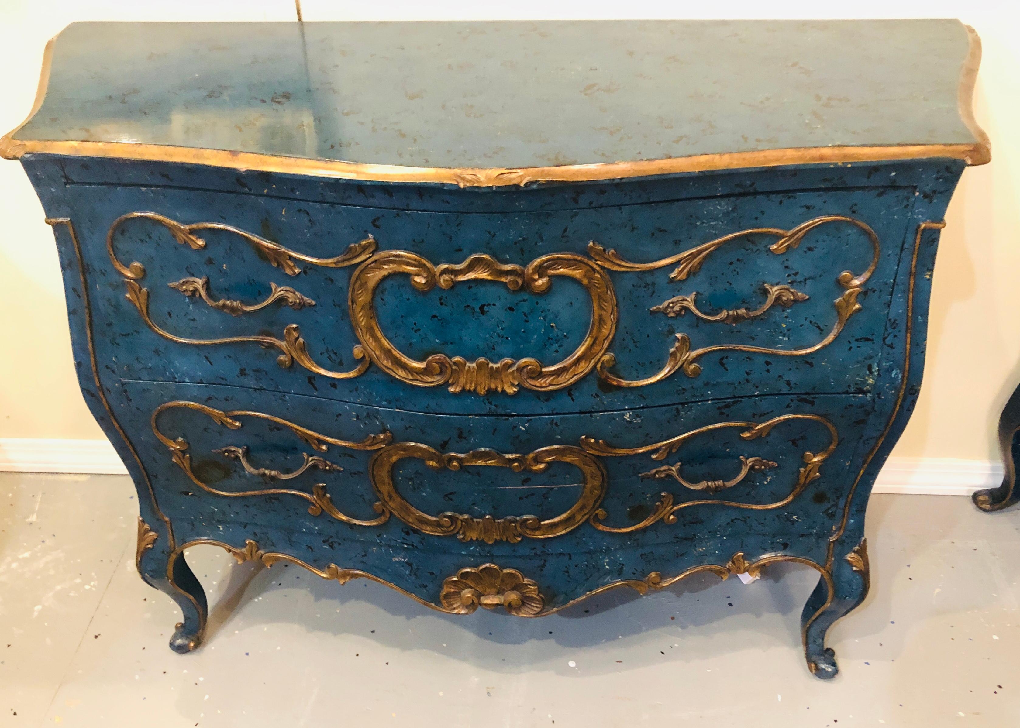 Pair of Royal blue and parcel-gilt decorated bombay commodes, nightstands or chests. These fine hand painted dramatic commodes or chests are simply stunning done in the Bombay Louis XV style this pair of Hollywood Regency commodes have wonderfully