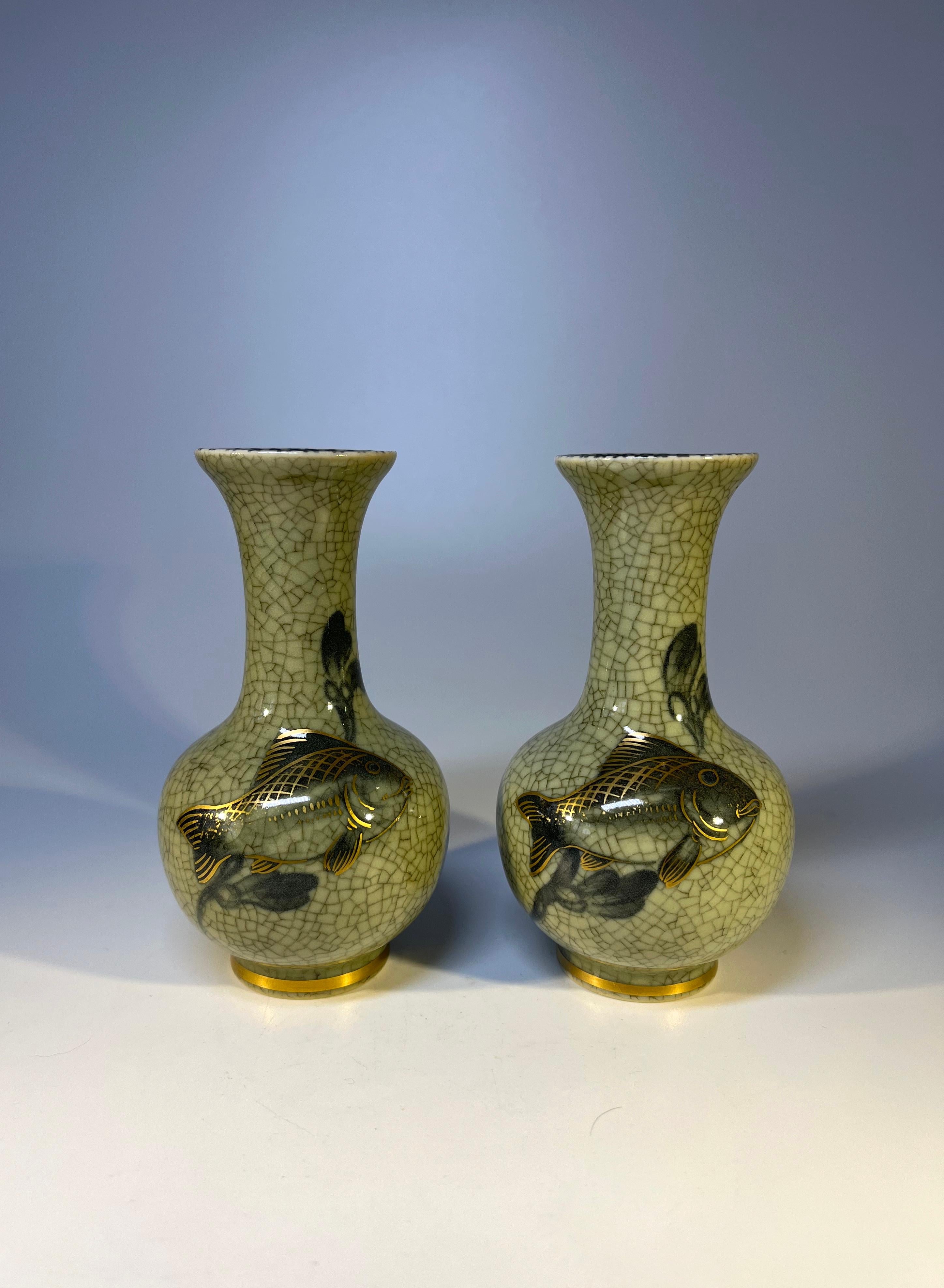 Delightful pair of Royal Copenhagen porcelain grey green crackle glaze bud vases
Hand applied gilded fish decoration and gilded bands on base
Circa 1960
Stamped and numbered 1554
Measures: Height 4.75 inch, Diameter 2.5 inch
In excellent