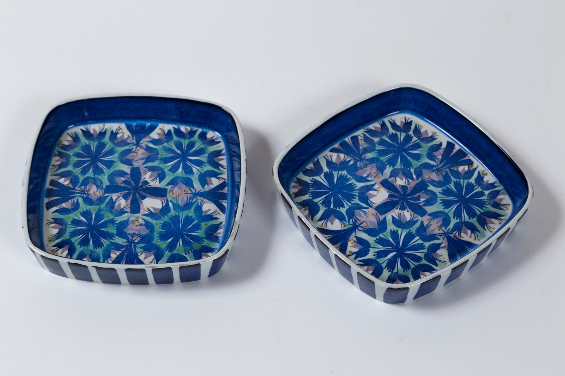 Pair Royal Copenhagen plates designed by Marianne Johnson, Denmark, circa 1950. An abstract floral design in richly glazed shades of blue. Signed 'MJ' by the artist and marked for Royal Copenhagen.