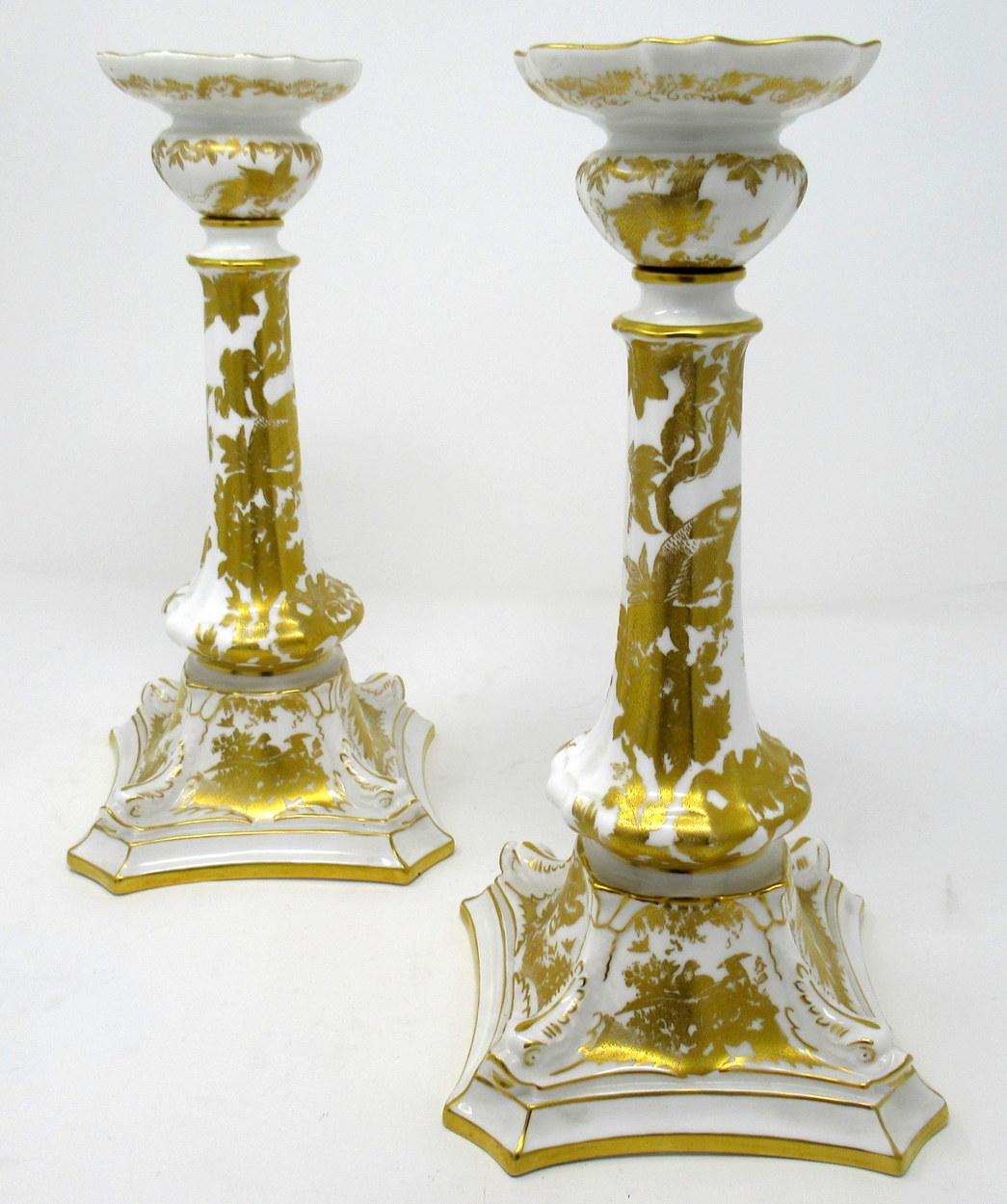 Superb pair of highly ornate Royal Crown Derby gold Aves pattern porcelain and gilt single light table or mantlepiece candlesticks of good size proportions, mid-20th century, 

Each of tall slender form with lavish raised gilt decoration depicting