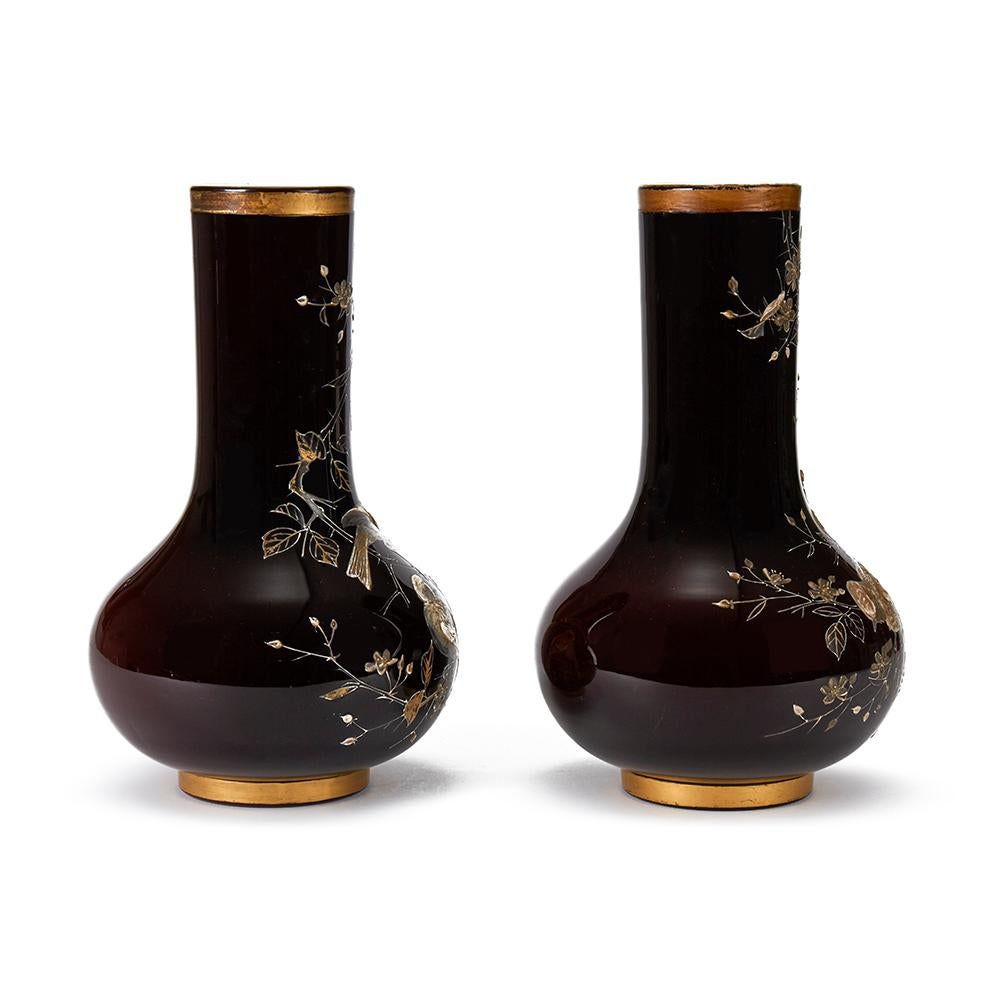 A very fine quality and rare pair of ruby overlaid white glass vases of rounded bottle shape, each applied in relief with birds perched on flowering branches. This finely made pair of vases, possibly made by Thomas Webb, both have polished bases and