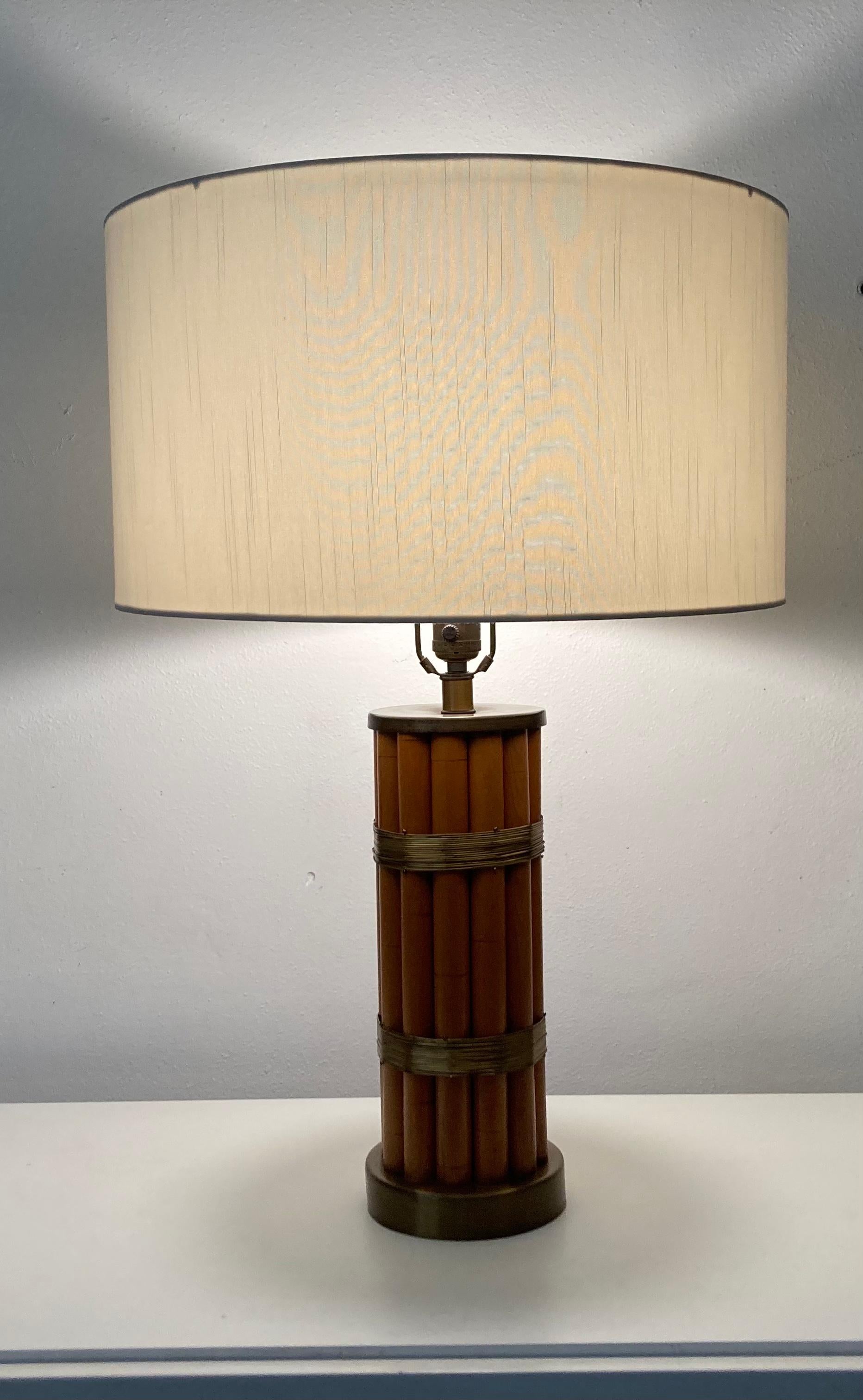 Pair of original Russel Wright Table Lamps, faux bamboo and brass. 
Table Lamp is 5.75” in diameter. Shade is 18.25” in diameter. 
Current lampshades have some spots and will be replaced by seller.