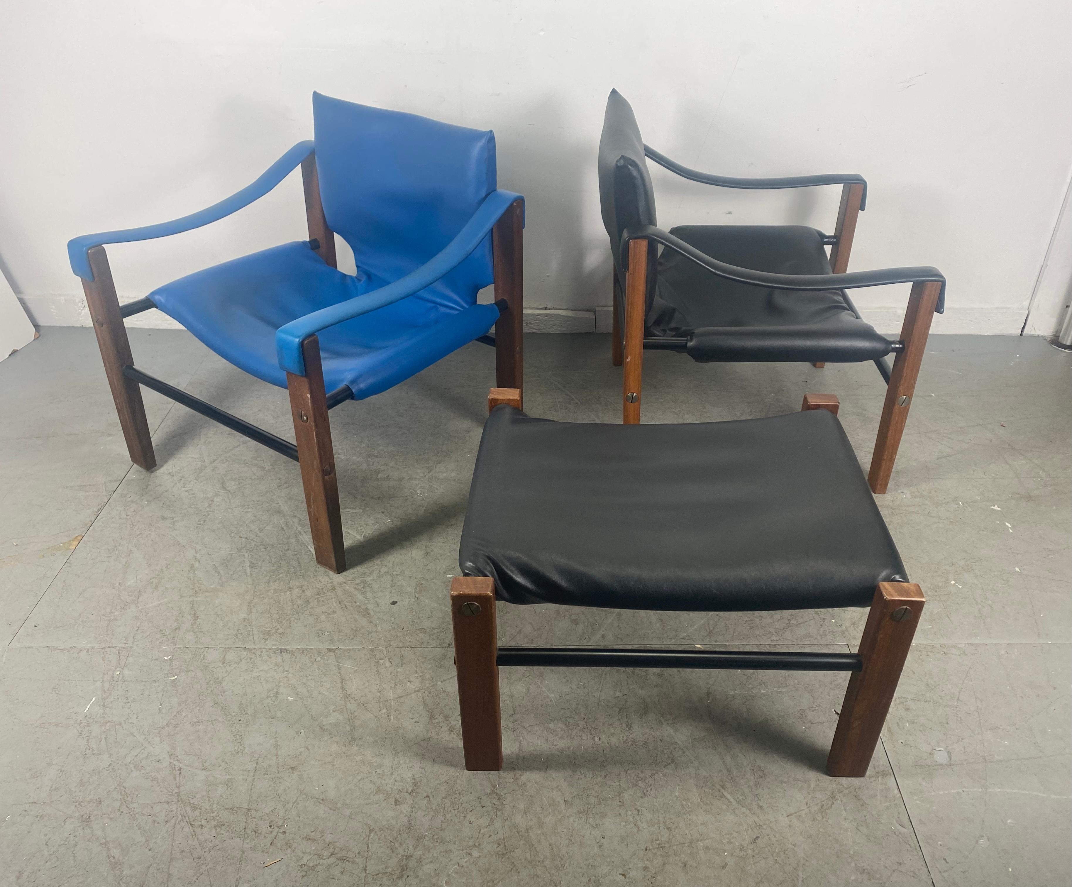 Pair Safari chairs and ottoman By Maurice Burke for Arkana 1970's. Nice pair retains original naugahyde in great condition. Both chairs have impressed mark / maker. Extremely comfortable. Minor bumps and bruises to teal frames. Hand delivery avail