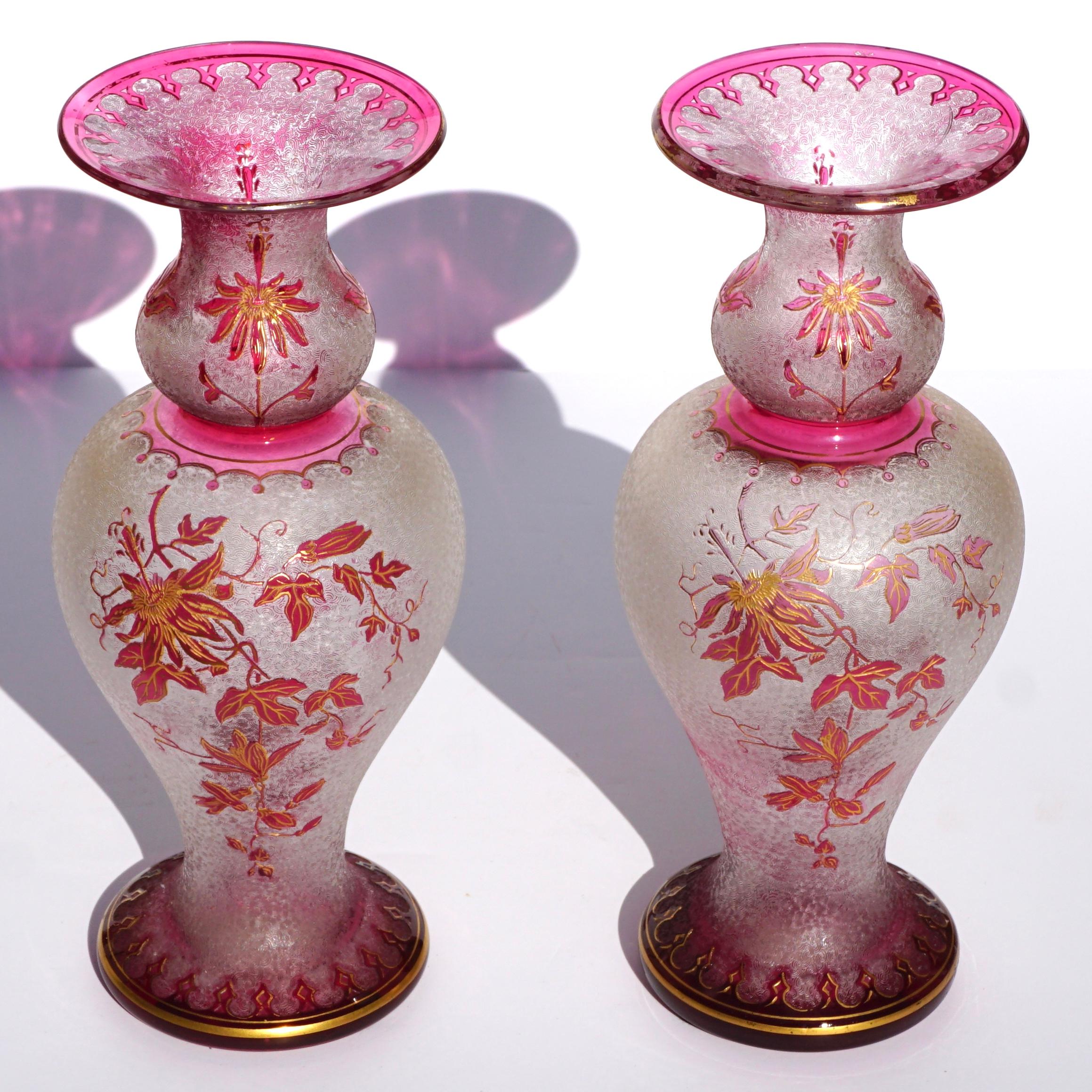 A stunning and gorgeous pair of St. Louis French Cameo and enameled Art Nouveau vases

Dimensions: 10.75 inches tall x 4.6 inches wide,

Clear acid cut background with cranberry red cameo carved overlay, floral enameled with gold stencil