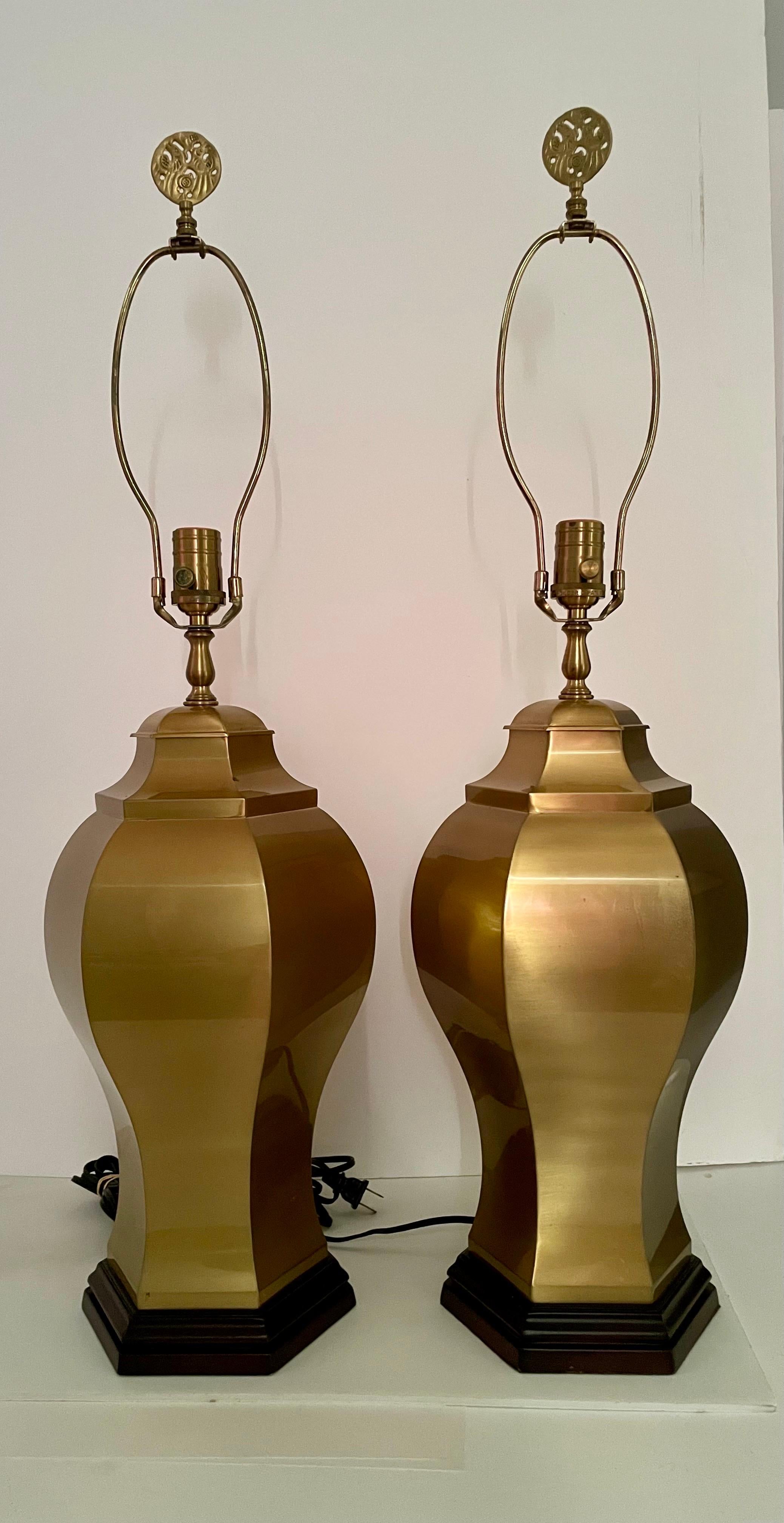 circa 1980s-1990s Pair of rewired satin brass ginger jar lamps on bases in the Hollywood Regency style. The lamps Measure 22