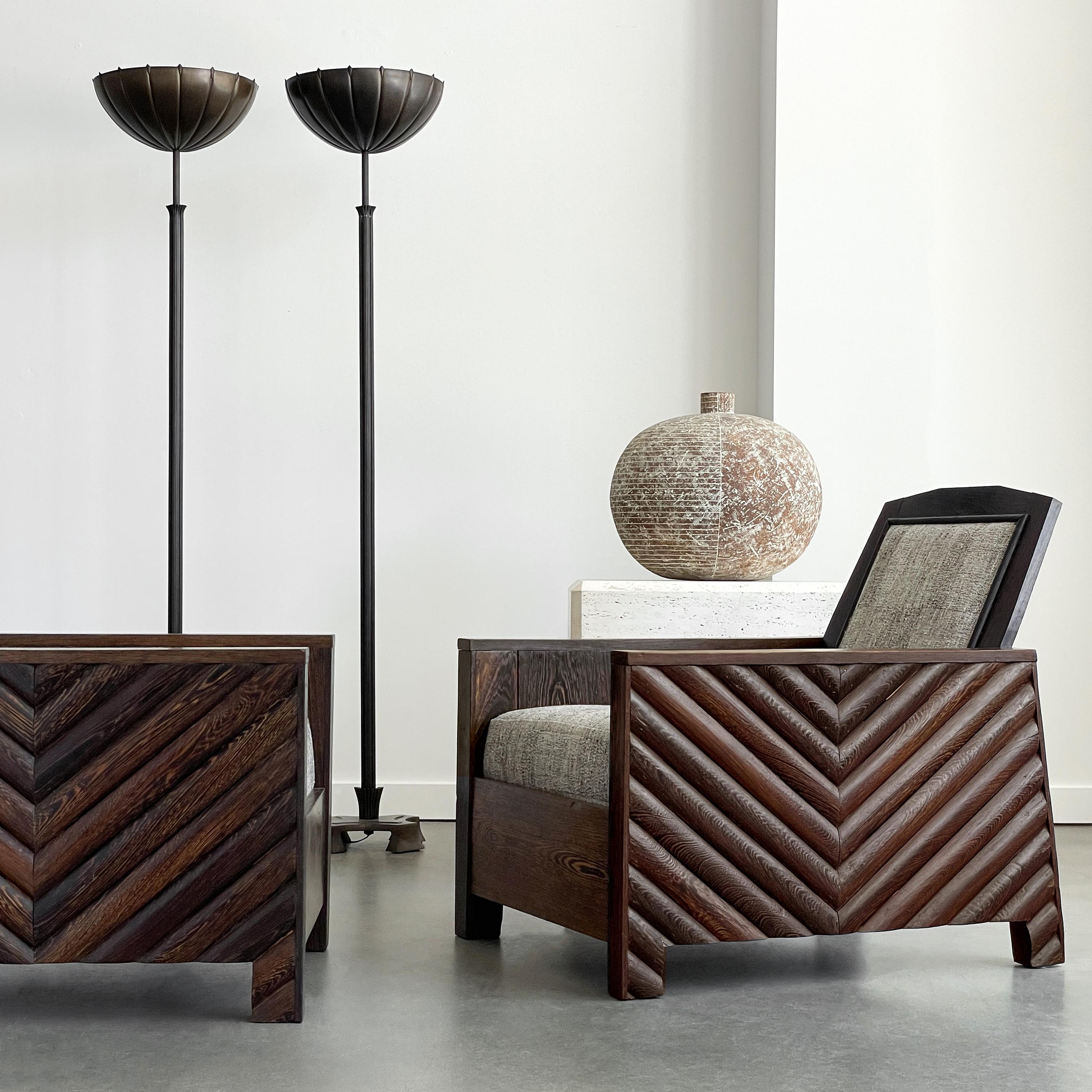 A rare and exquisite pair of hand-crafted Scandinavian Modernist/Art Deco club lounge chairs, circa 1920s. These solid wenge wood chairs, possibly one of a kind, offer a unique blend of minimalist design and rustic charm, making them a sophisticated