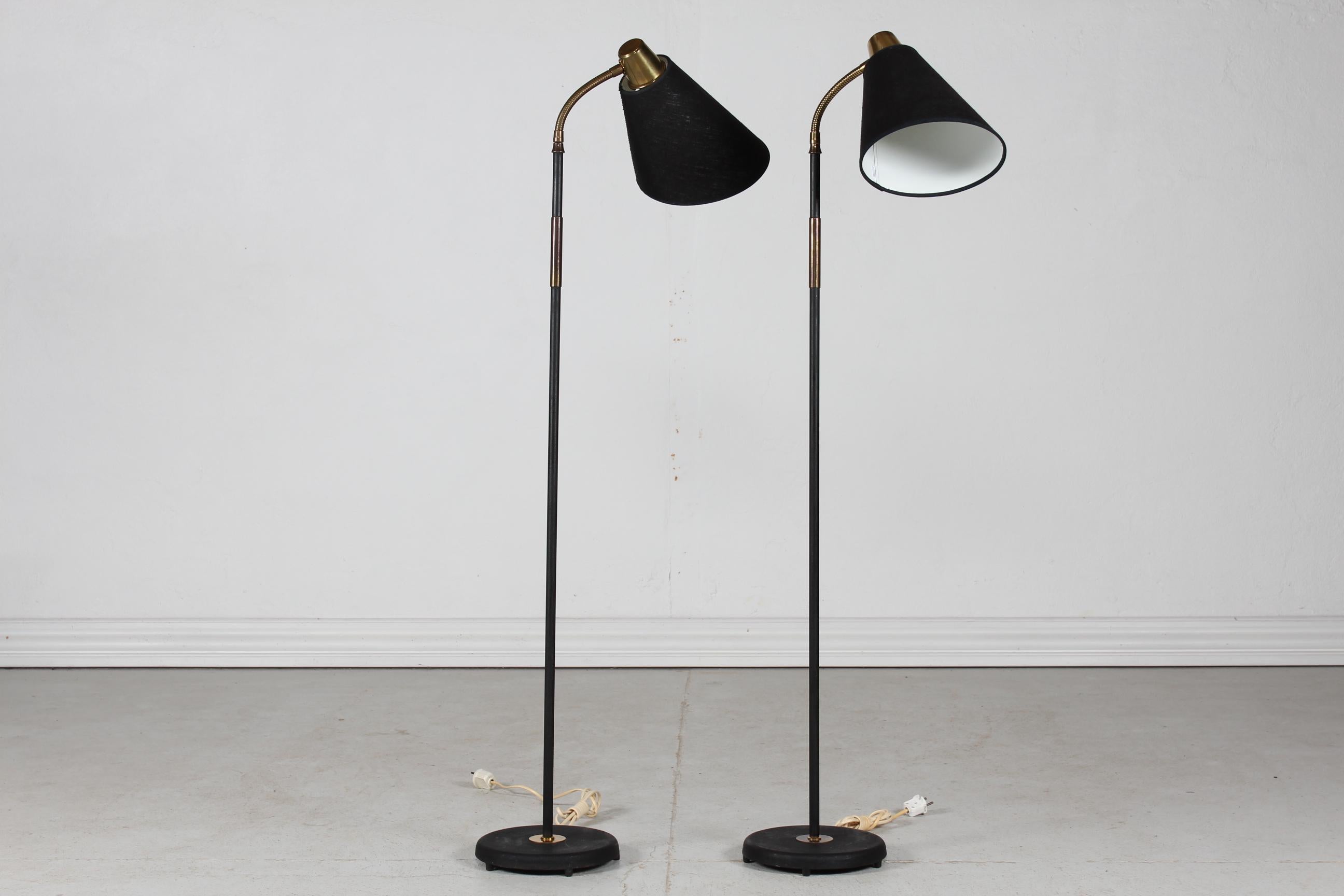 Scandinavian light design.
Pair of floor lamps 1940s made of metal with black lacquer, frame mounted with brass. 
The newer oblique cut lampshades are made of black woven fabric.

From the same period and in the style of Josef Frank - Paavo