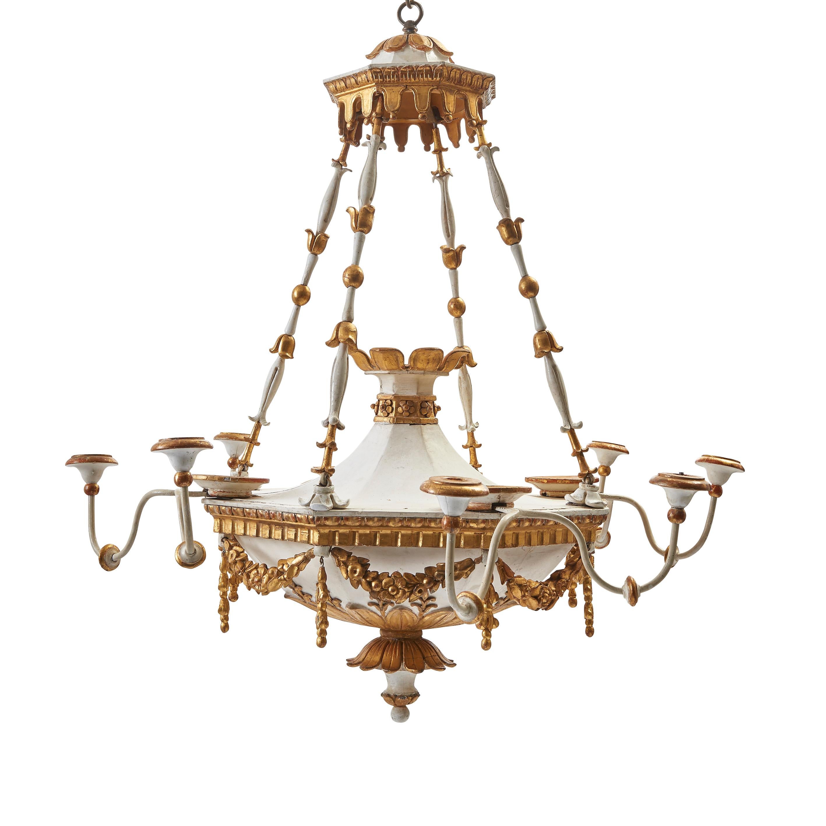 Pair of early 19th century neoclassical parcel-gilt and white painted carved wood chandeliers, Scandinavian, circa 1810. In a typically neoclassical style, with the base of each chandelier decorated with foliate swags and a central finial focal