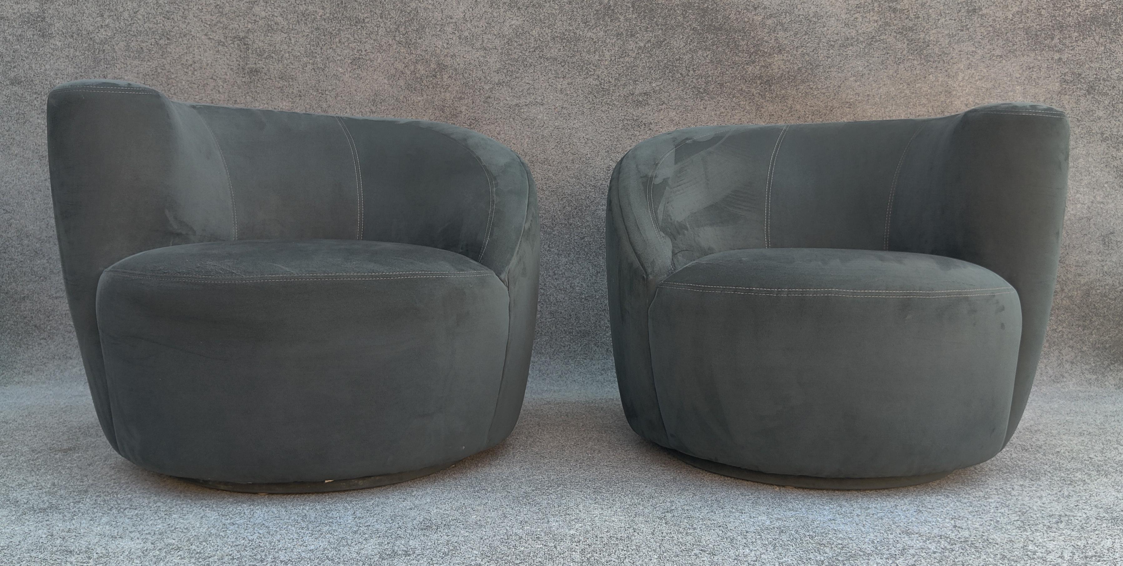 Reminiscent of the Nautilus chair, designed by Vladimir Kagan in 1950, here is a sculptural pair (left and right) of iconic mid-century modern swivel lounge chairs. Its distinct and organic design features a curved, shell-like shape made of suede or