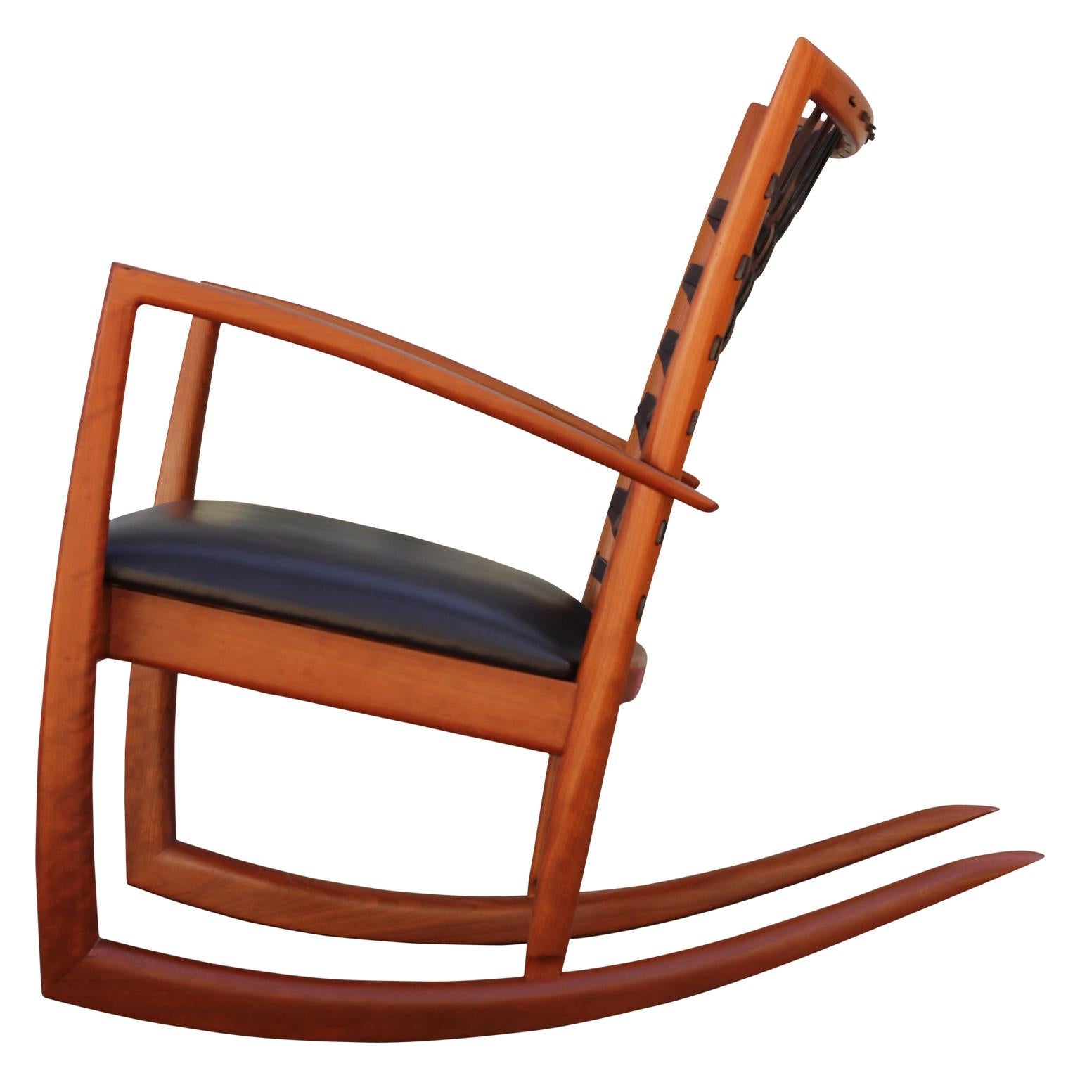 Sculptural modern cherrywood rocking chair
- Made by Houston Crafter roger deatherage
- Made with cherrywood
- Adjustable woven leather backing
- Leather seats
- Modern sculptural design
- Sold as pair or individually.