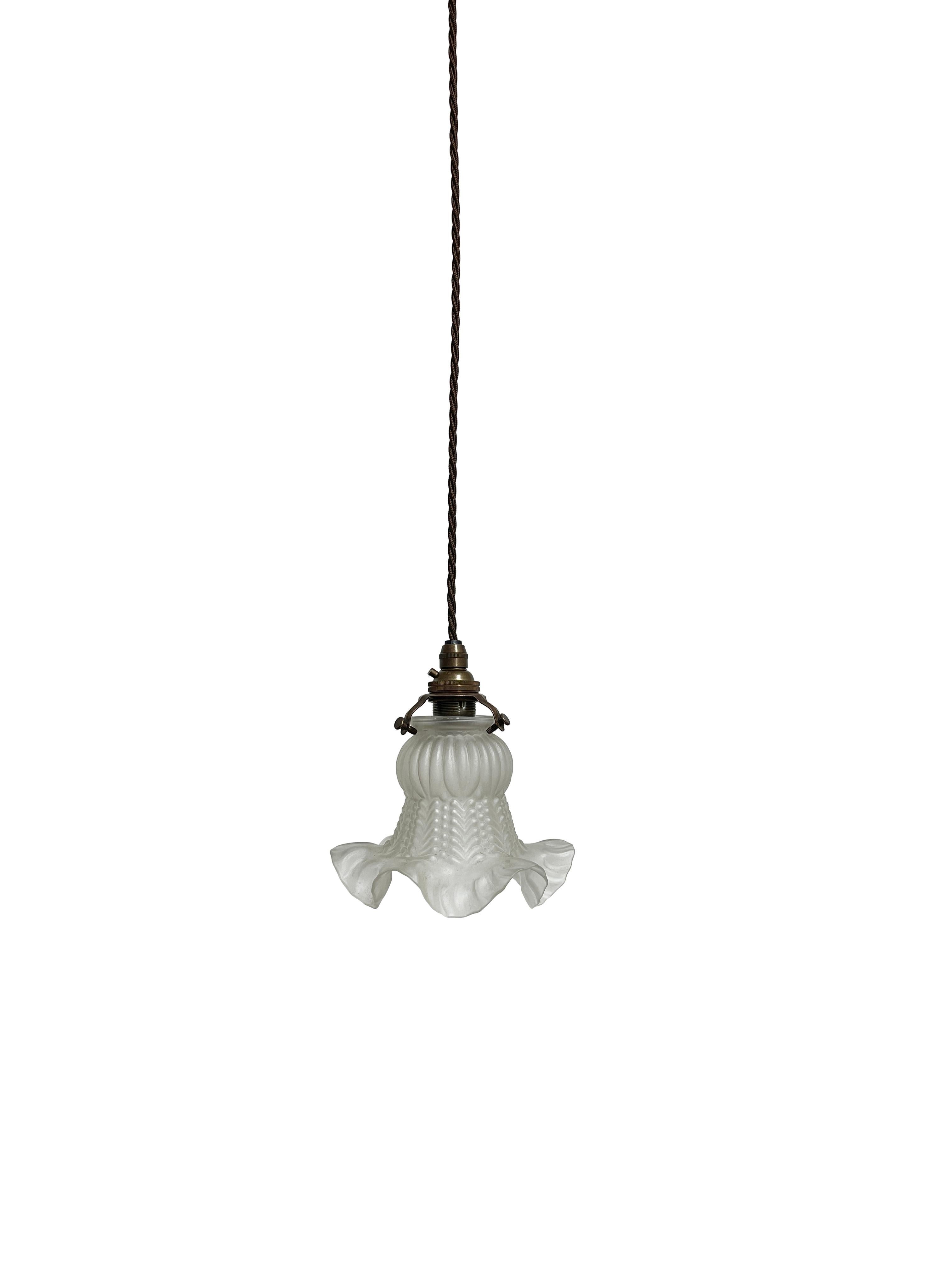 - A fabulous pair of frilly pendant light shades, French circa 1930.
- Frosted glass 'tulipe' shades both with brass holders and original decorative ceiling roses.
- Ideal as swag pendants or suspended bedside lighting, in beautiful vintage