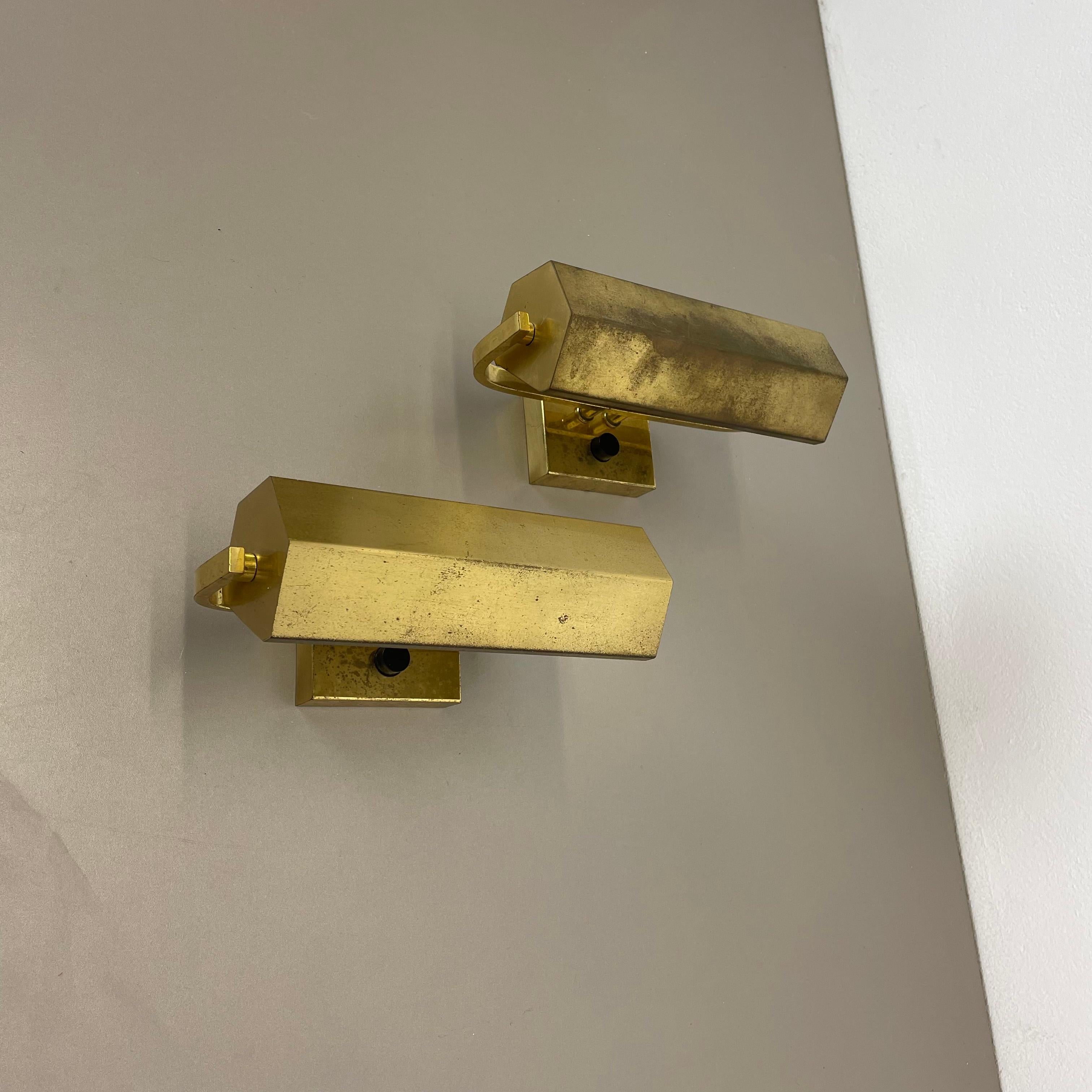 Article:

wall light set of 2



Origin: Germany in the manner of Stilnovo and Hollywood Regency style.



Age:

1970s



This modernist light set was produced in Germany in the 1970s. It is made from solid metal and brass with 1