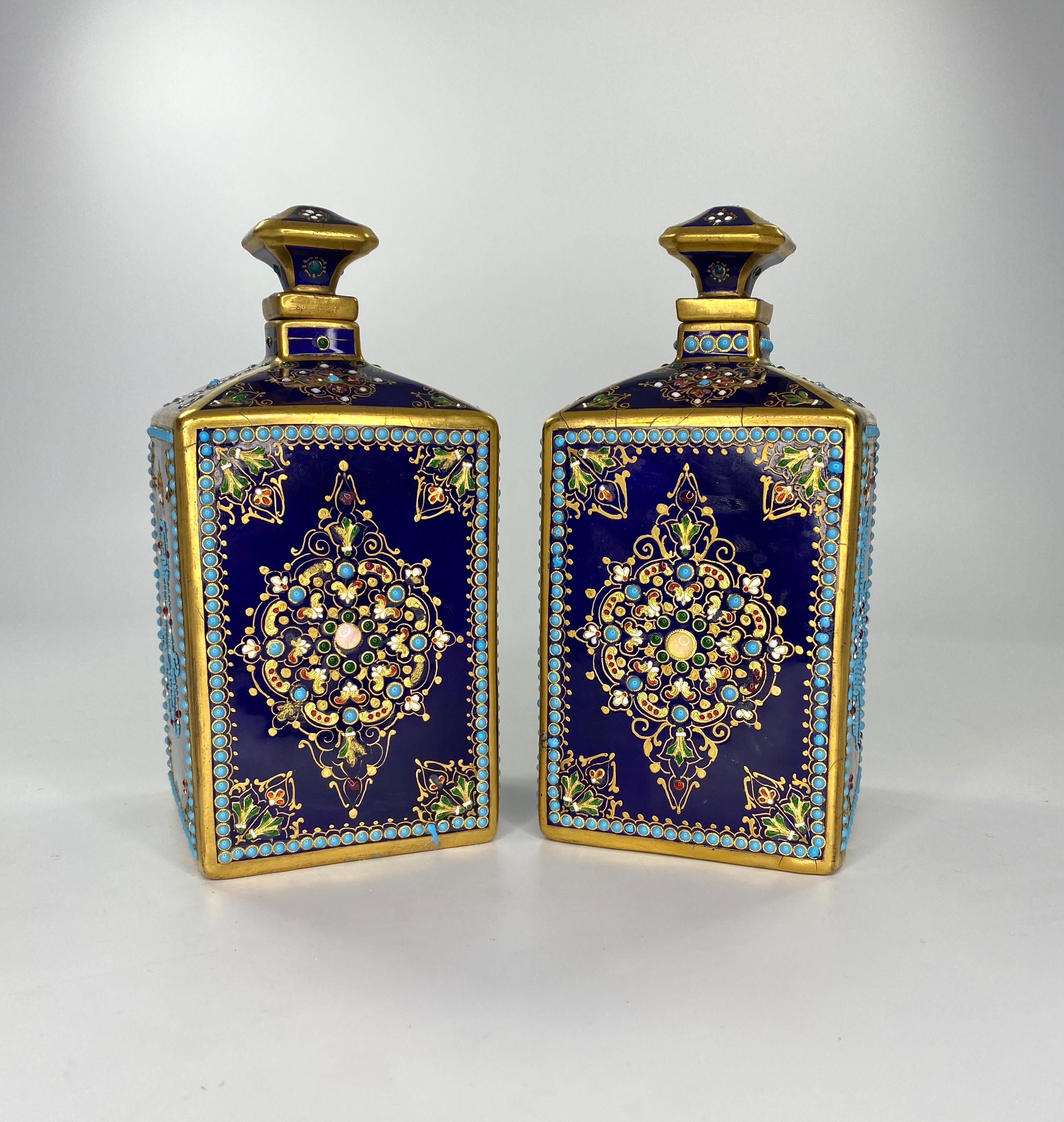 Pair of Sevres style ‘Jewelled’ perfume bottles, circa 1880. The square form bottles, ‘jewelled’ with the monogrammed of Louis XVI, and Marie Antoinette, beneath gilt crowns. The other sides, decorated with elaborate gilt scroll motifs, embellished