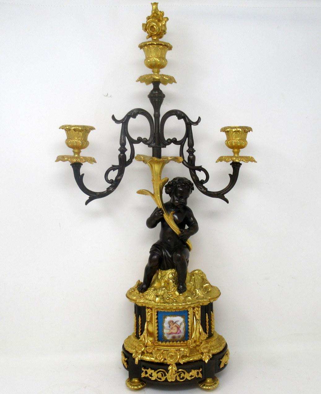 A fine stylish and imposing pair of French three light table or mantle Sevres porcelain mounted ormolu candelabra of outstanding quality. Early to mid-nineteenth century. 

Each with two scrolling leaf capped and one central branch above a chisel