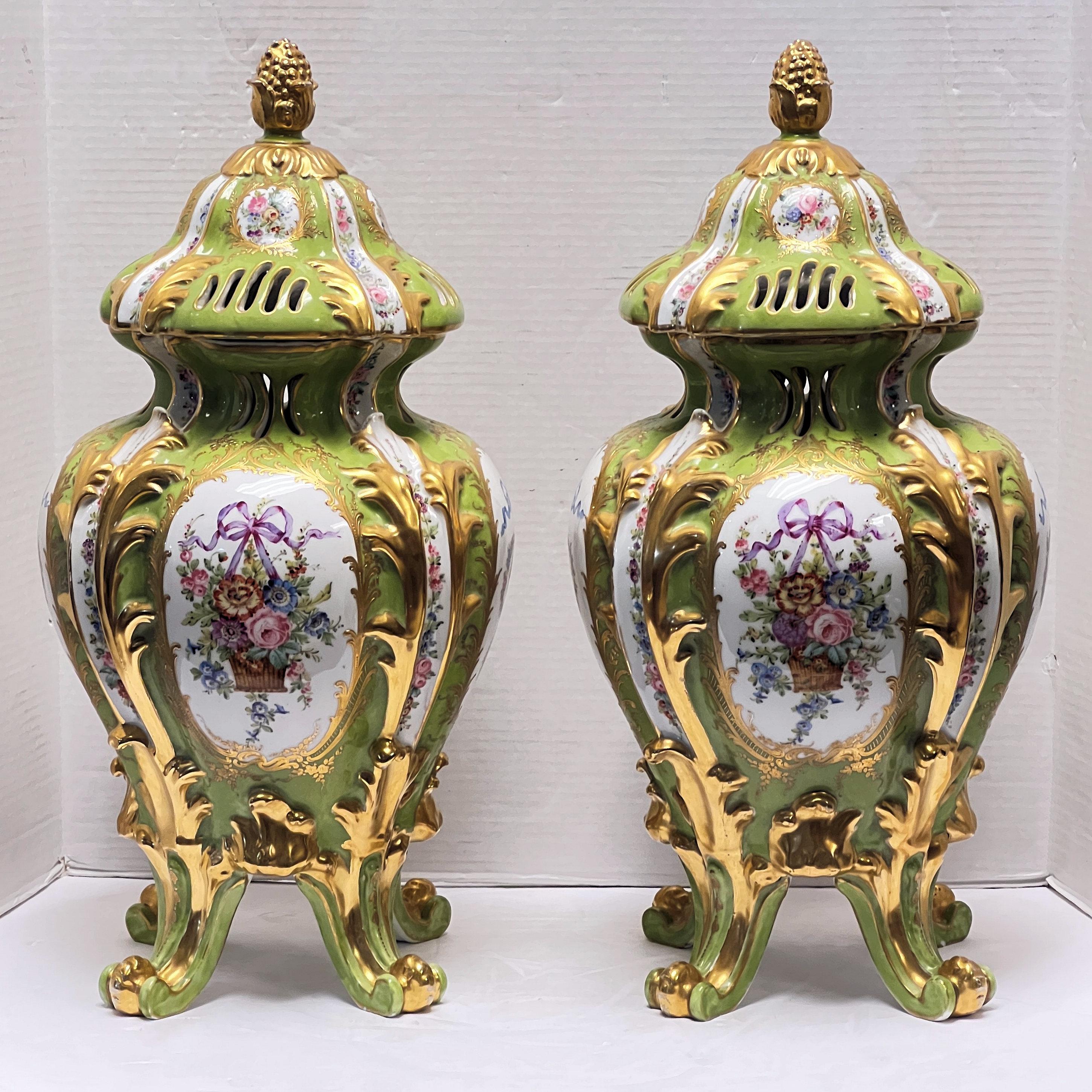 Pair of very unusual turn of the century Green color Sevres Style Floral Painted and Gilded Porcelain Urns.