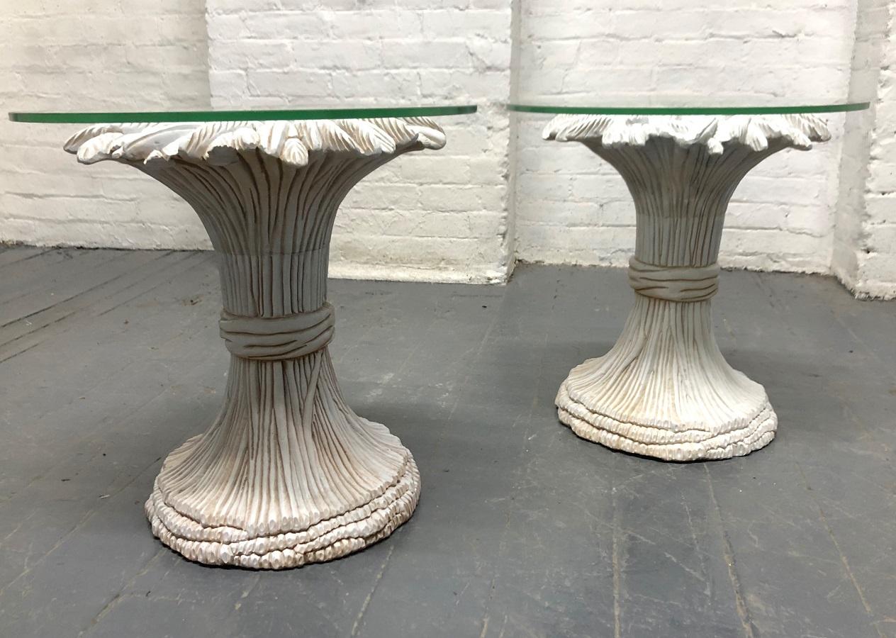 Pair of sheaf of wheat wood and glass top side tables. The tables have a white painted finish with round glass tops.
