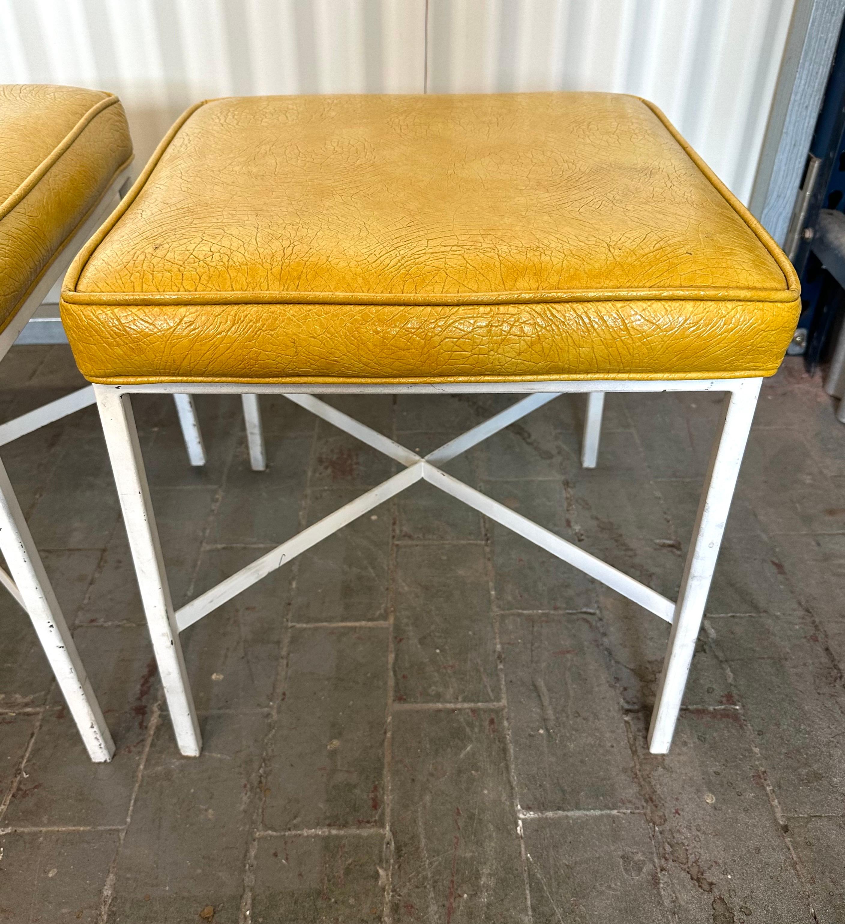 Classic mid-century design, the square seat upholstery in its original dark yellow skai. On white enameled frame with x-stretcher.