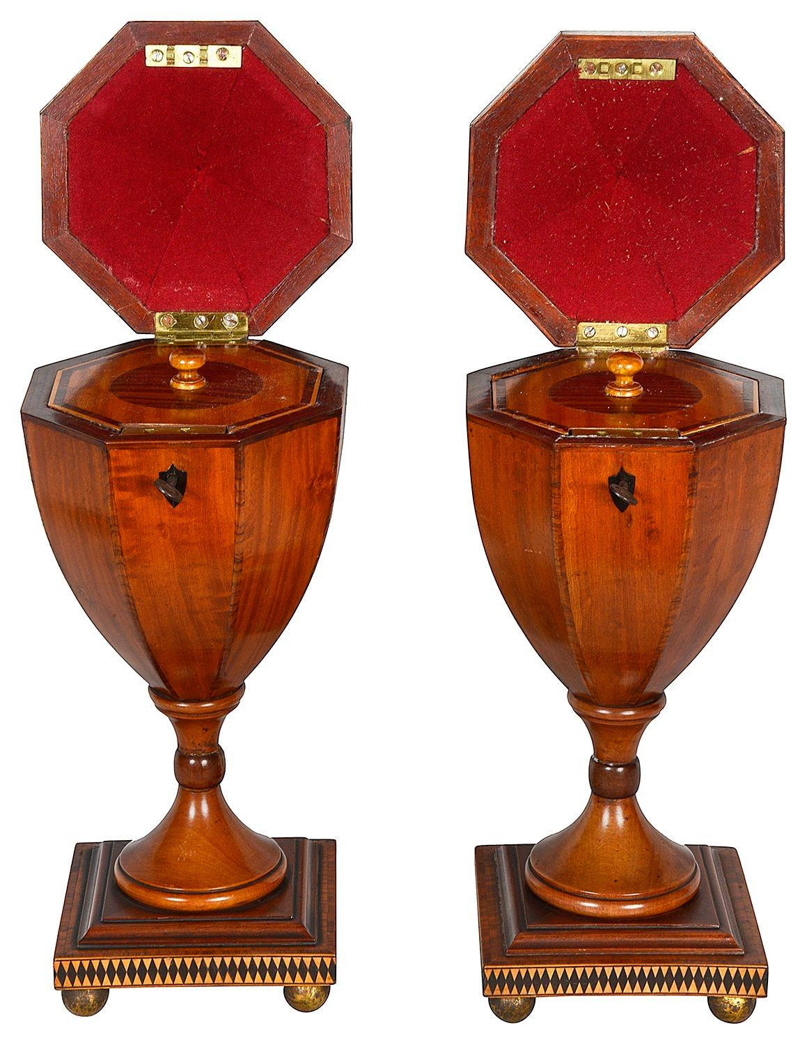 A very good quality pair of Sheraton revival Mahogany Urn shaped tea caddies, each with Acorn finials segment veneered lids, opening to reveal two octagonal inlaid lids. Two bands of Ebony and Boxwood diamond shaped inlay, Ebony escutcheons and