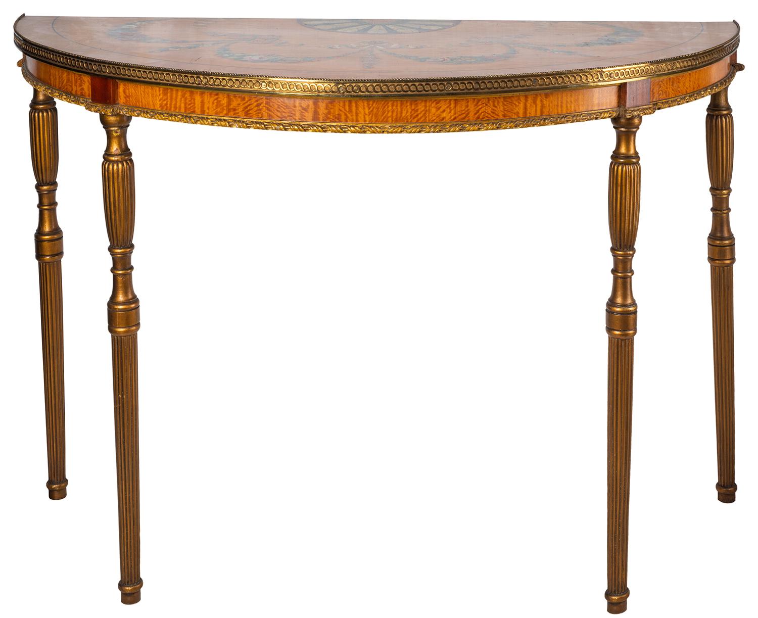 An beautiful pair of 18th century style Sheraton revival satinwood demilune side tables, each with wonderful hand painted floral swag, feather and ribbon decoration to the top, gilded ormolu moldings to the top and frieze, raised on turned tapering,
