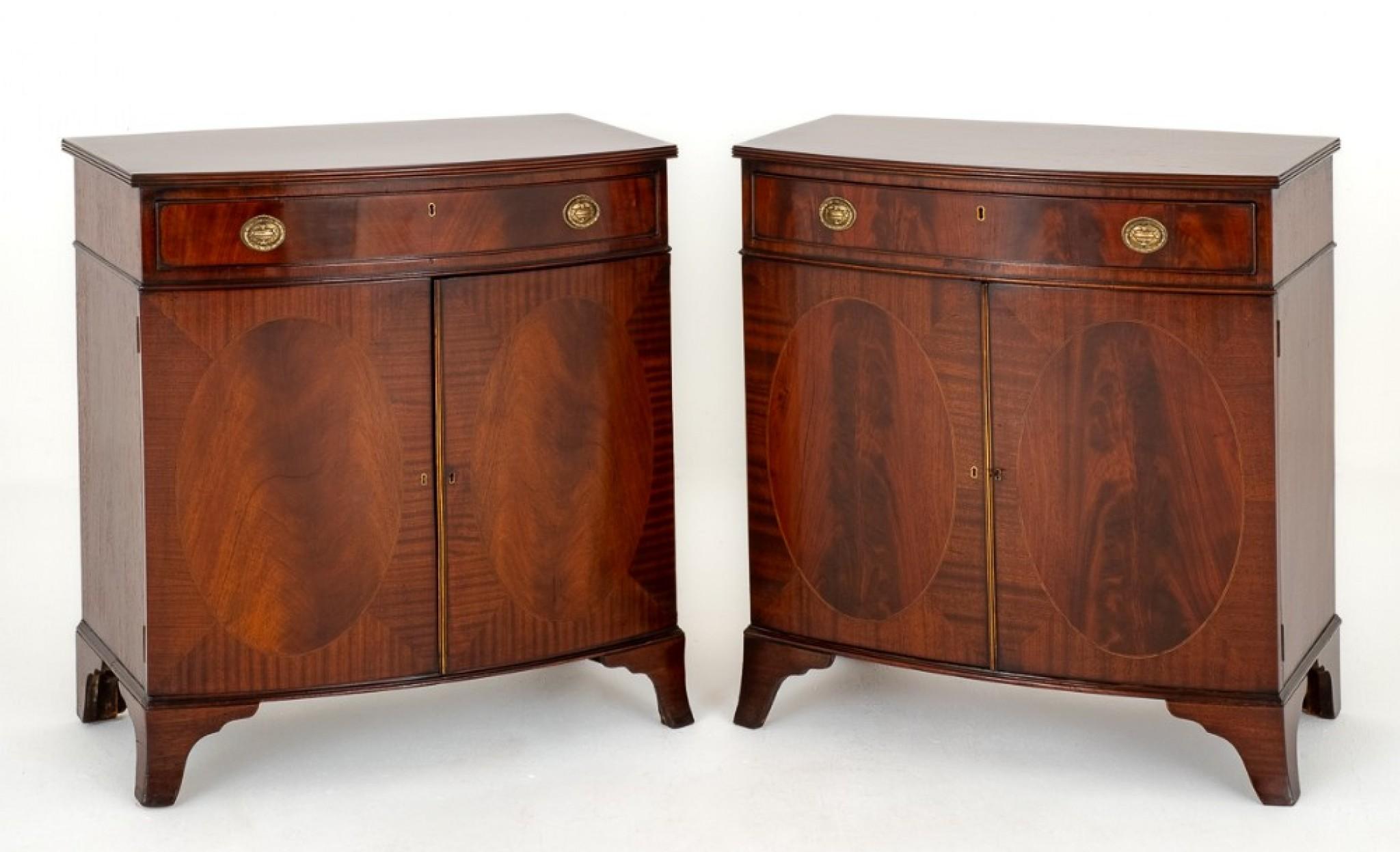 Pair of Mahogany Sheraton Revival Bow Fronted Cabinets.
These Cabinets Stand upon Splay Feet.
Circa 1920
Each Cabinet Having 2 Doors with Oval Panels with Wonderful Flame Mahogany and Ebony and Boxwood Inlaid Lines.
The Oak Lined Drawers Retaining