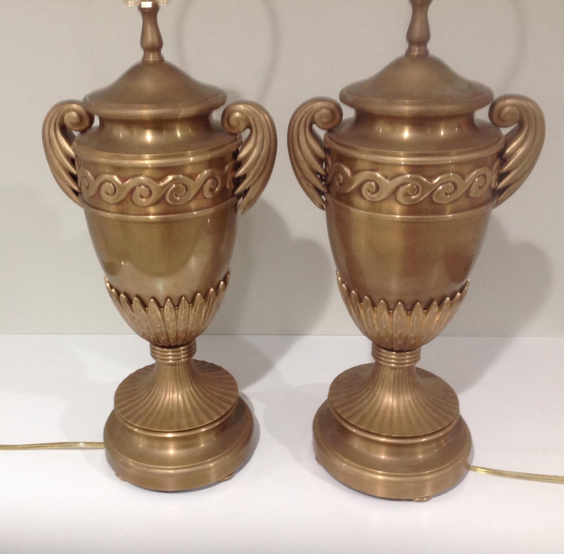 Large and very decorative pair of Chapman urn form lamps. Lamps are either brass or bronze. Lamps retain original harps and finials. Circa 1980’s. 

Chapman Manufacturing Company, Inc. is a world renowned leader in the home furnishings industry.