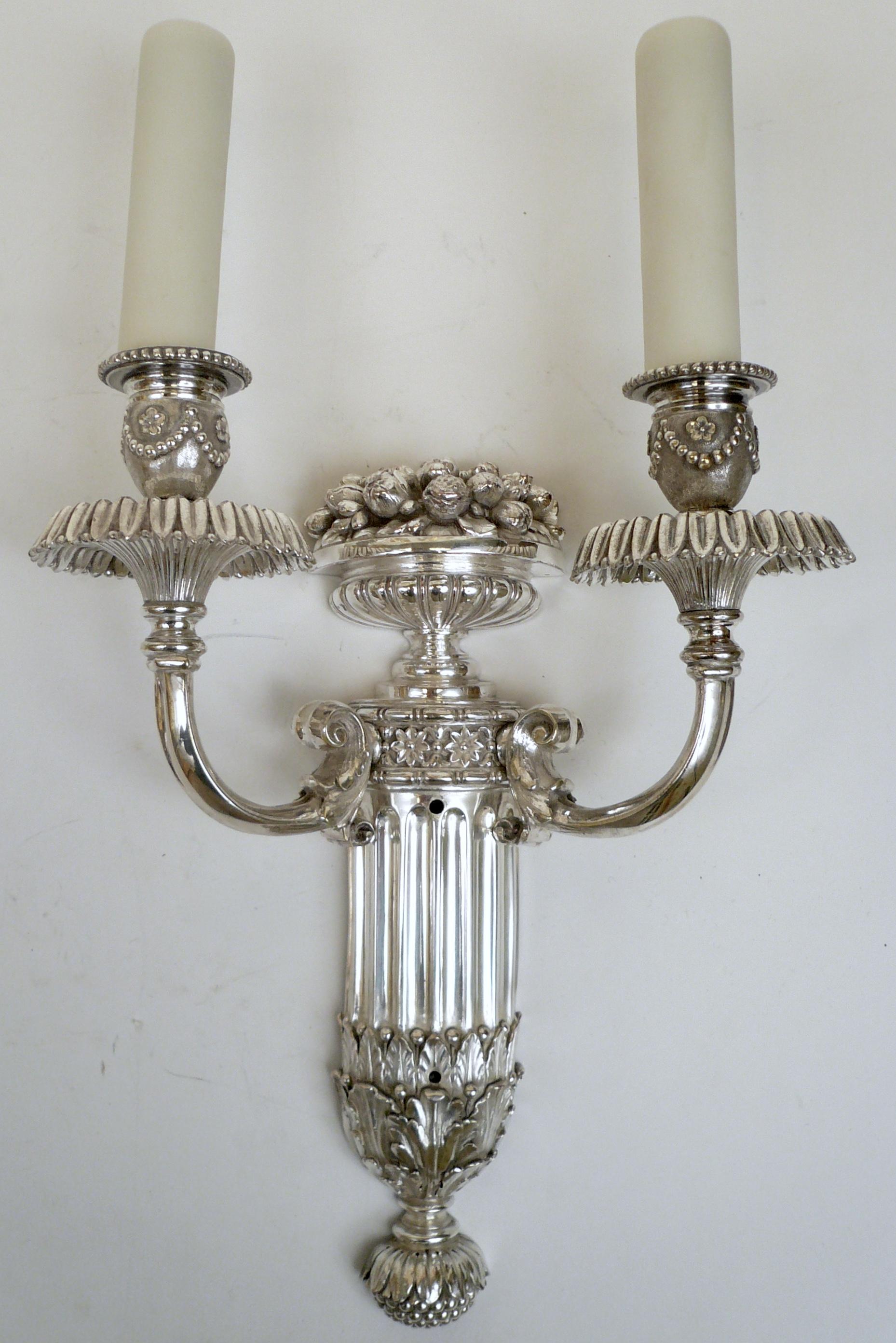 This finely detailed pair of Caldwell sconces feature classical motifs including acanthus leaves, swags, and rosettes.