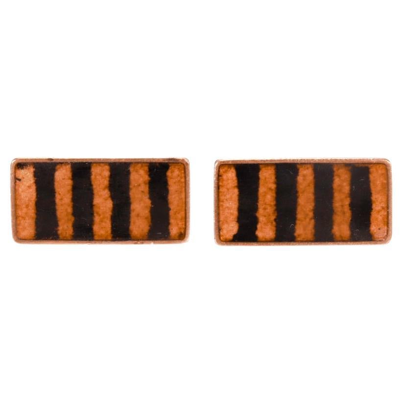 A fine pair of German Modernist brass cufflinks.

By Scholtz & Lammel.

With alternating black and orange striped enamel decoration.

Simply a wonderful pair of cufflinks!

Date:
20th Century

Overall Condition:
They are in overall good,