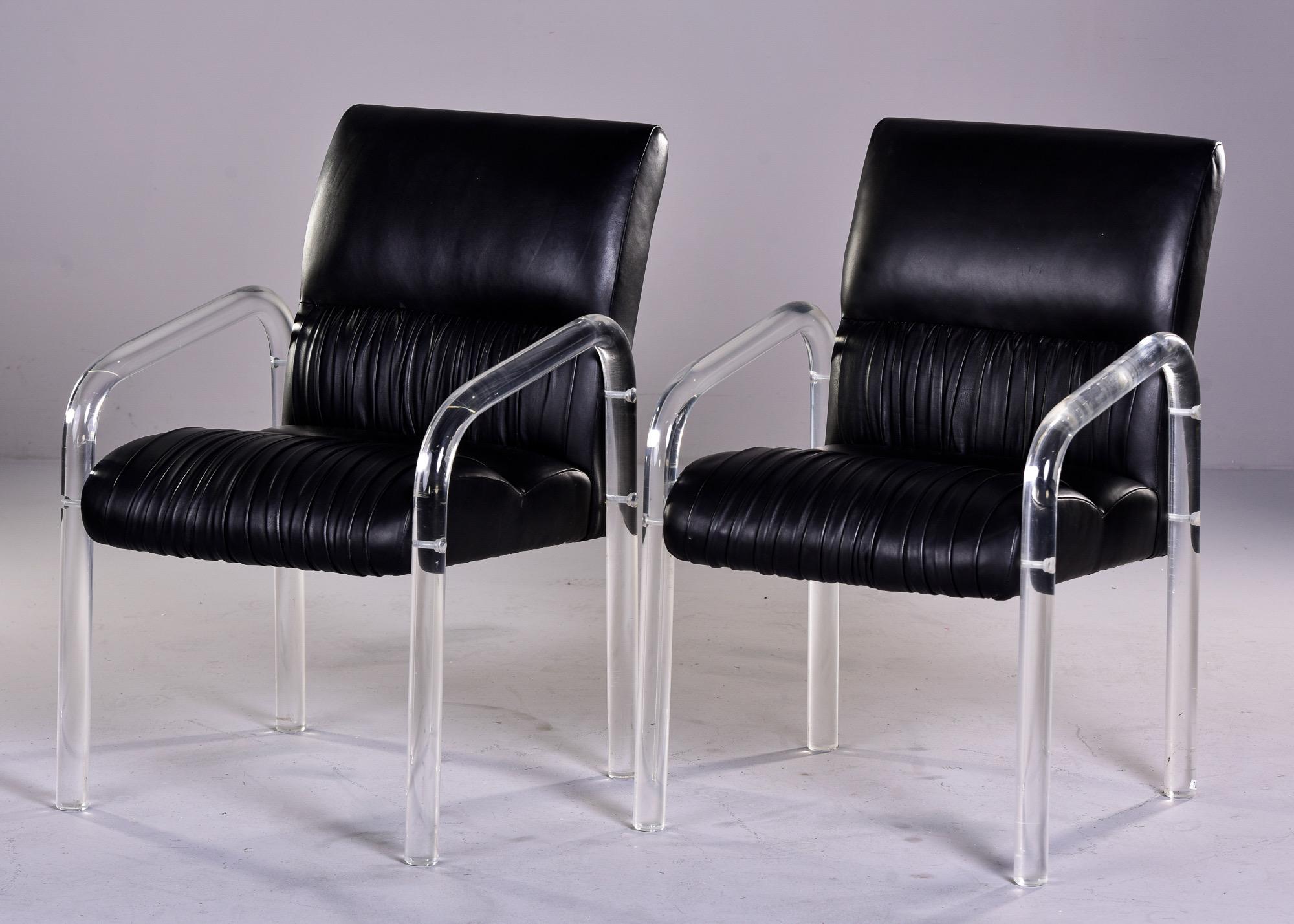 Circa 1980 pair of lucite and black leather armchairs by Lion in Frost. Original leather in very good vintage condition with gathered details at the back and seats. Maker’s etched signature on leg. Sold and priced as a pair. 

Measures: arm