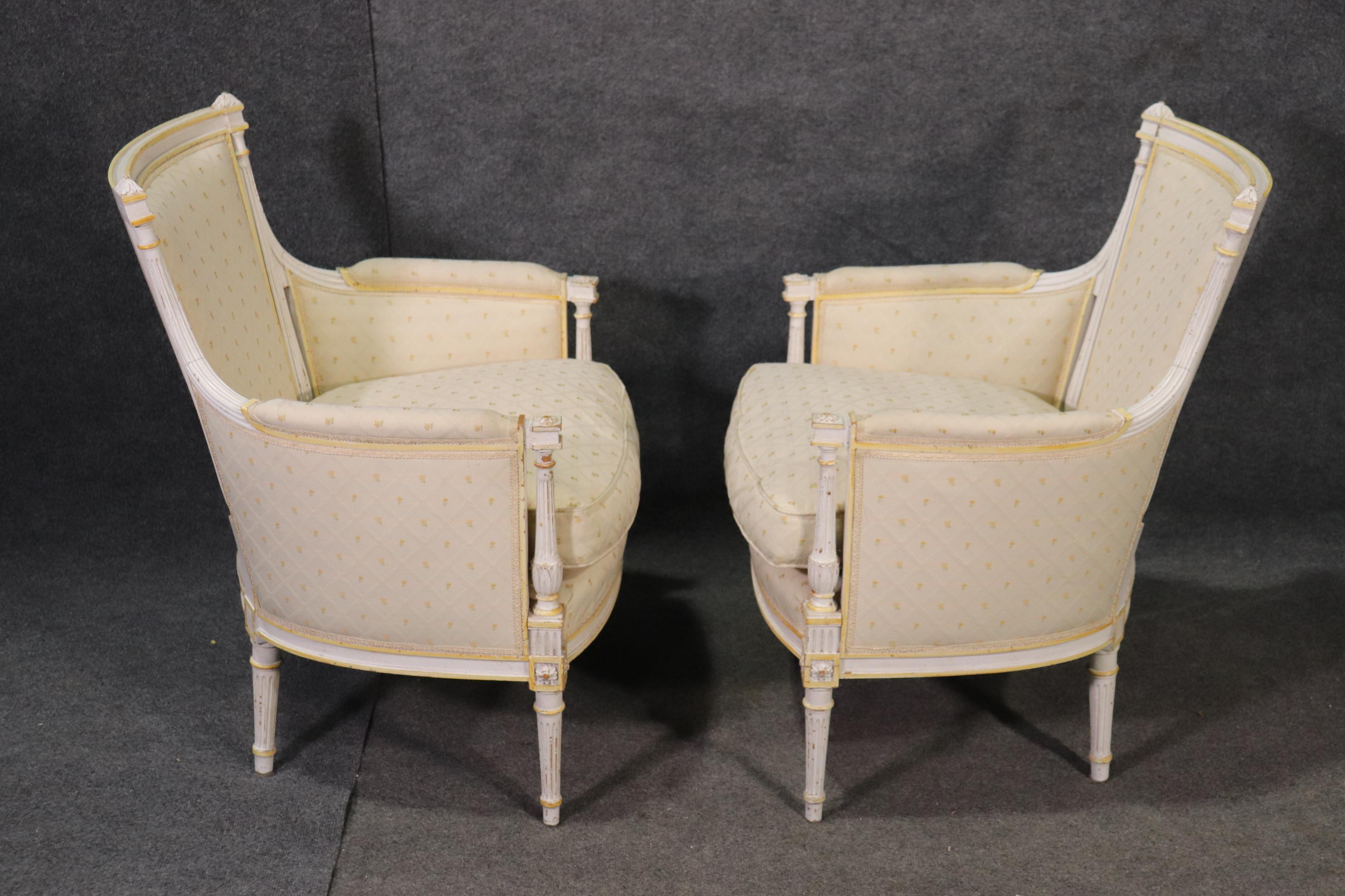 This is a signed pair of Maison Jansen bergère chairs with some subtle yellow highlights and in good condition. The chairs each measure 35 tall x 27 wide x 27 deep and the seat height is 20 inches. These are beautiful designs and in good vintage