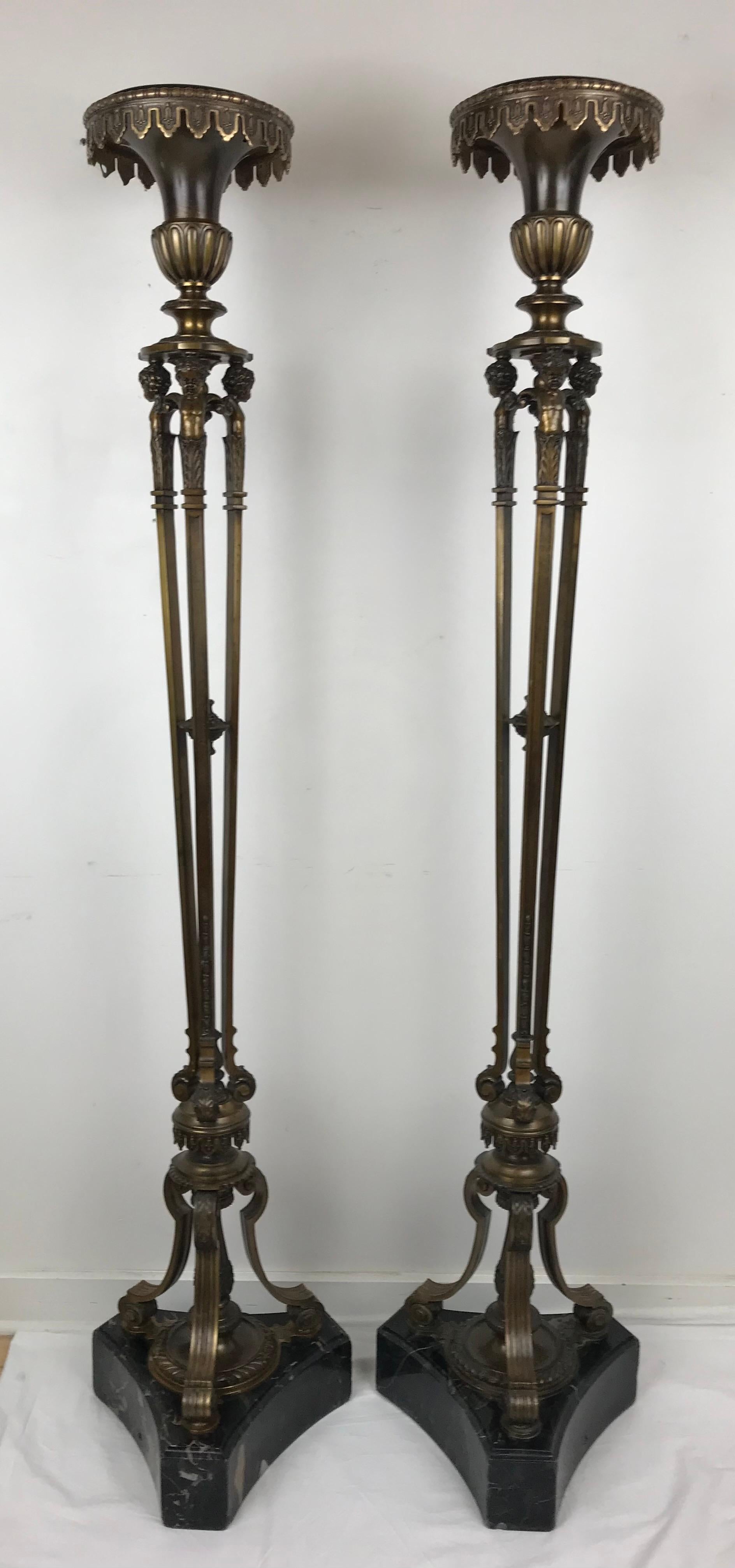 This handsome pair of stands, or gueridon are wired and could be used with lamps, gerandoles, or candelabra. They would also be useful used as pedestals for art objects, plants, or flower arrangements..
They are made of cast bronze and black marble