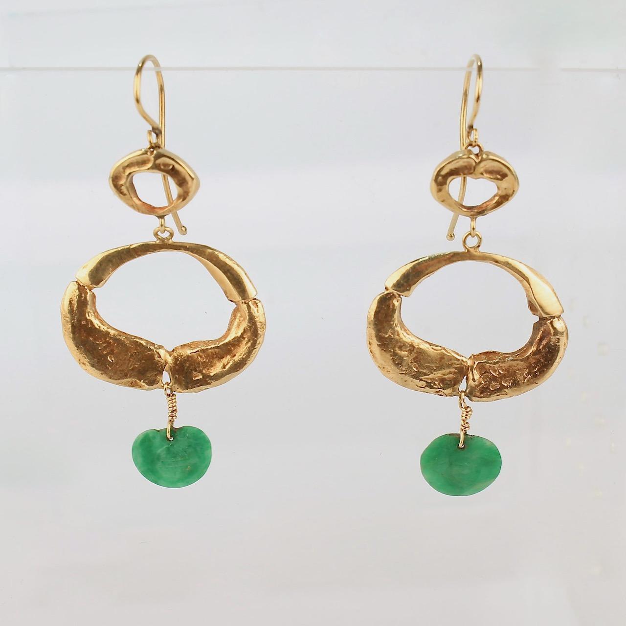 A very fine pair of Wesley Emmons modernist 14 karat gold & jade pendant earrings.

Each earring features 2 hand hammered oval rings and terminates with a small engraved disc of spinach (nephrite) jade. 

The jade pendants are engraved with Chinese