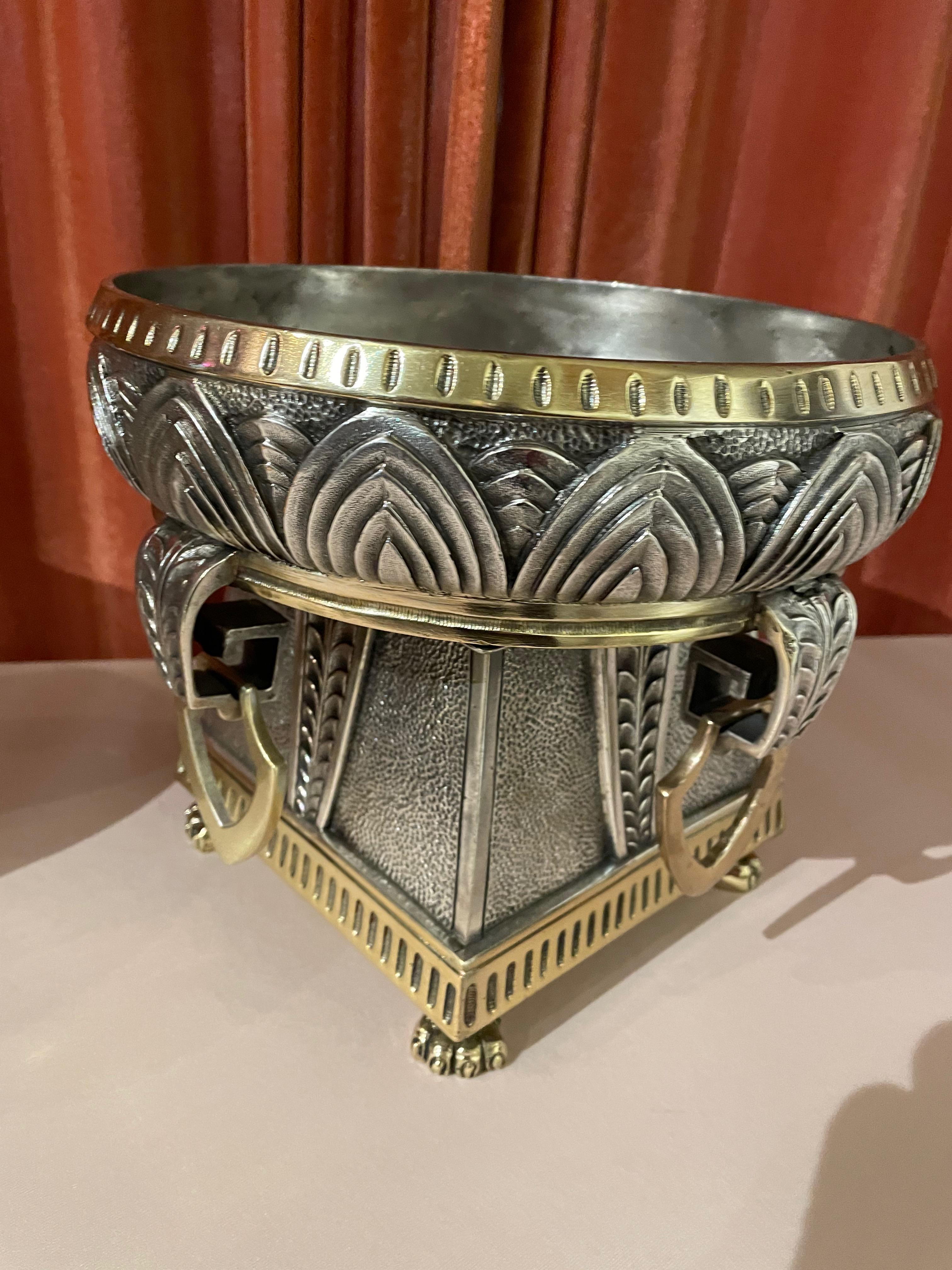 Elegant two-toned Art Deco silvered bronze jardinières with intricate detailing. The rich use of metals with great design and dimension makes this pair of planters or display bowls so very unique. The gold-toned feet, trim, and handles are in nice
