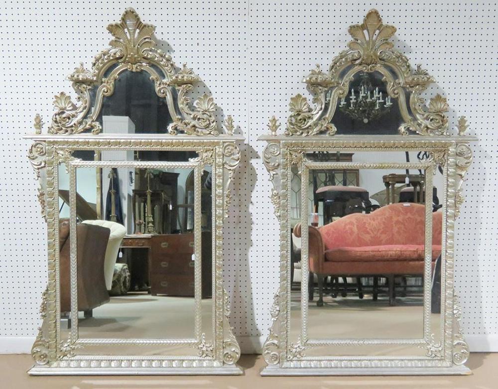 This is a beautiful pair of LaBarge mirror made in Italy. They are done in silver leaf and are in good original condition with good plate mirror glass. The mirrors measure 62 tall x 37 wide x 4 inches deep.