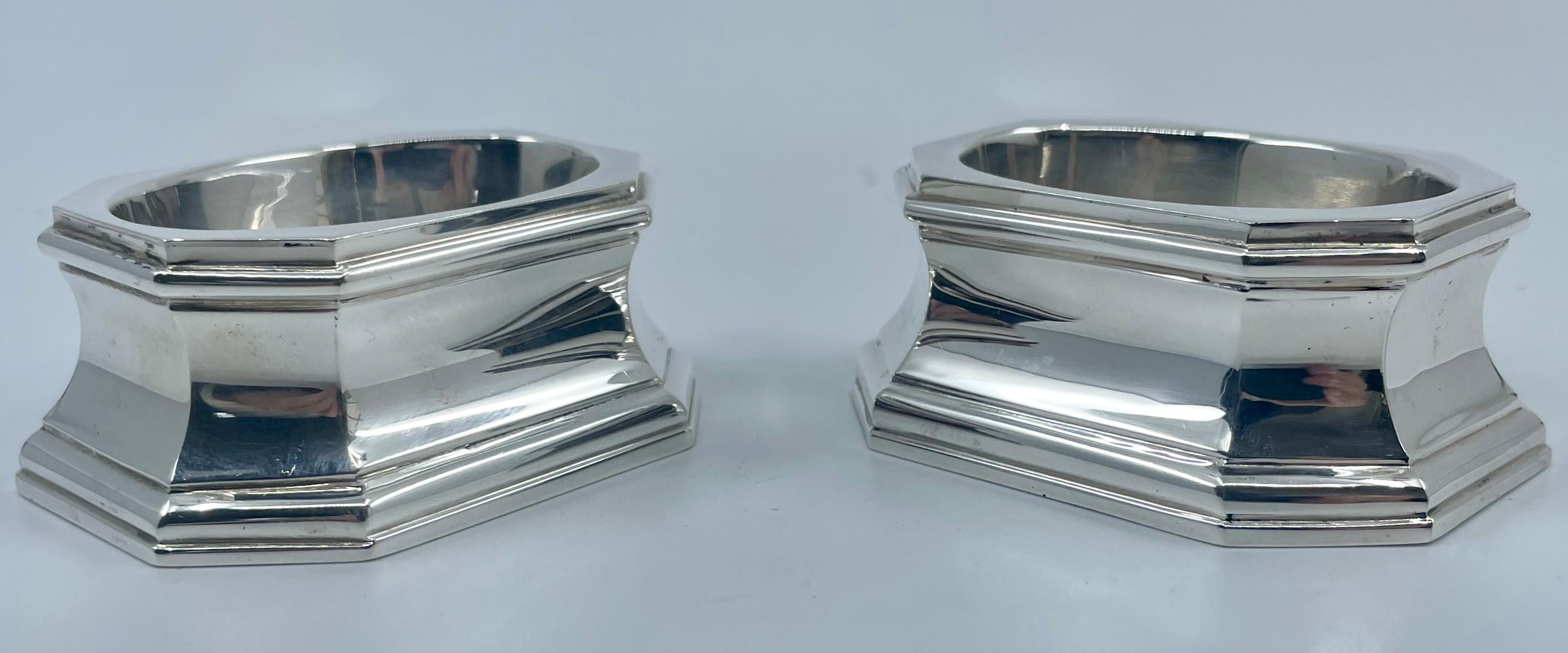 Pair silver pedestal salts. Pair handsome Edwardian era Sterling silver trencher form salts with oblong octagonal base and traces of vermeil to basins; with silver marks for Howard & Company. England first quarter 20th century. 
Dimensions: 2.88