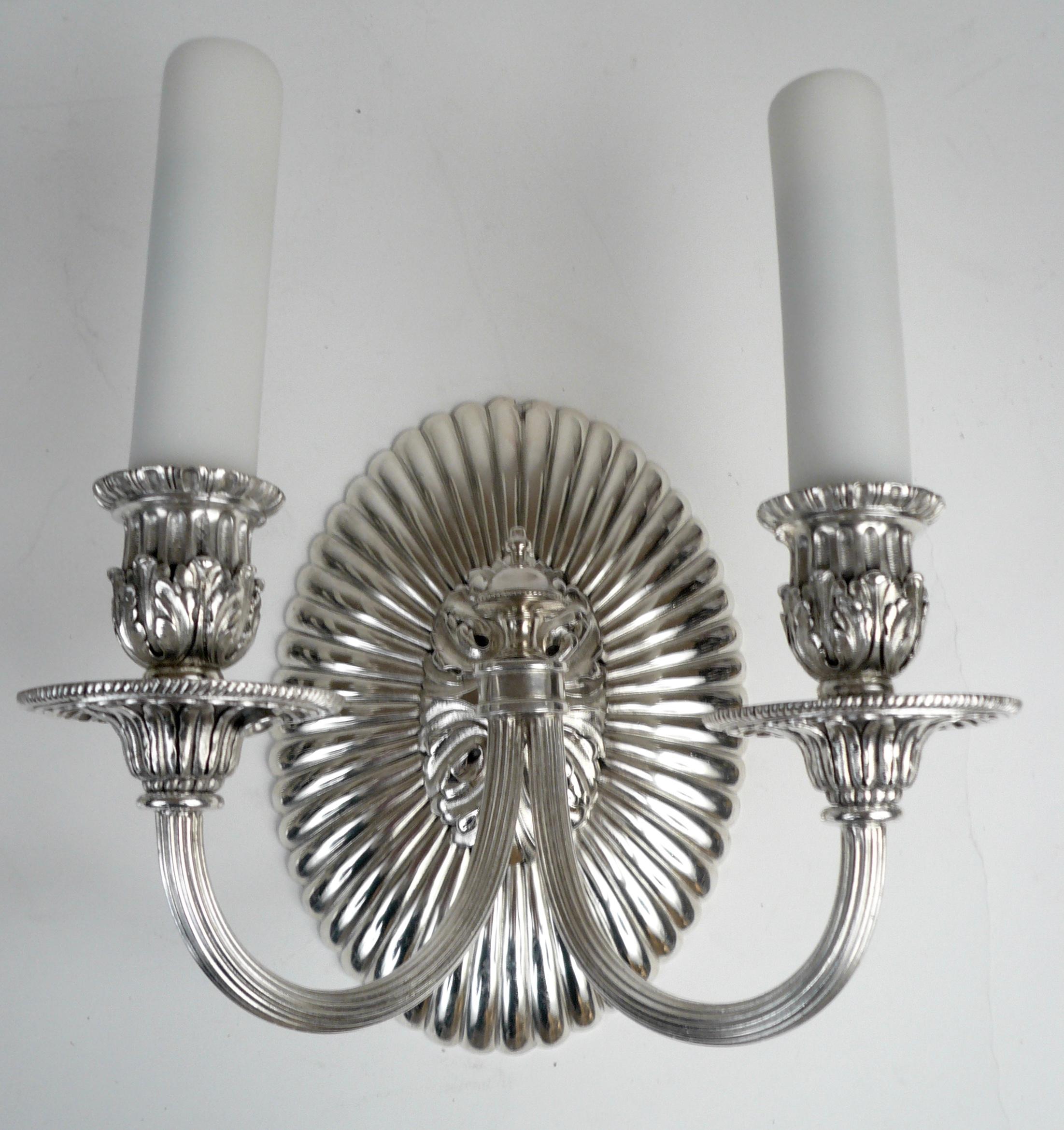 This impressive pair of twin arm bronze sconces retain their original silver palting and have been newly rewired, and are ready to use.
They are finely cast and feature classical motifs including beaded borders, and acanthus leaves.