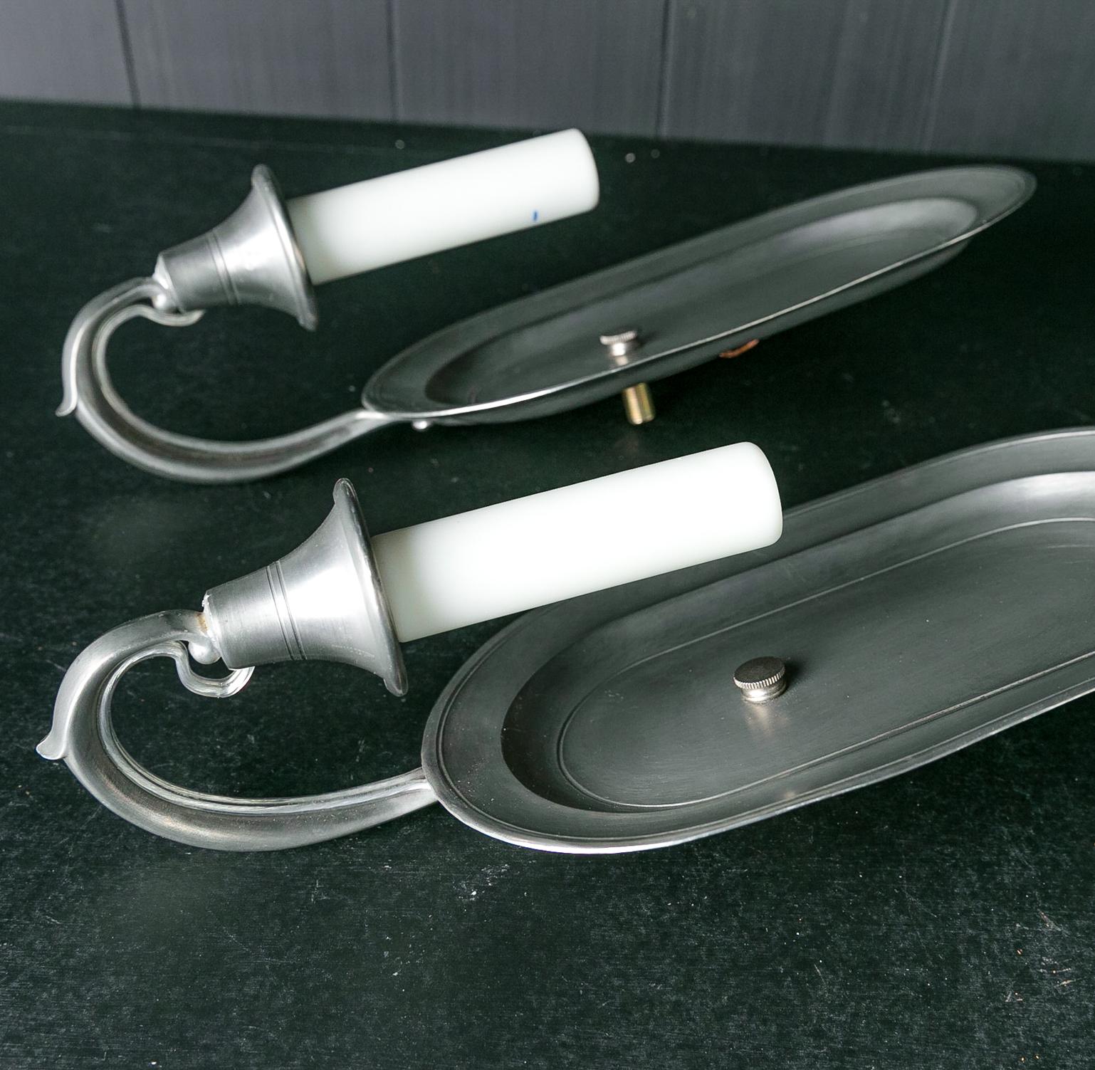 This pair of pewter sconces was made in the US. They have been newly-wired for the US. They have a very pleasing oval shape.