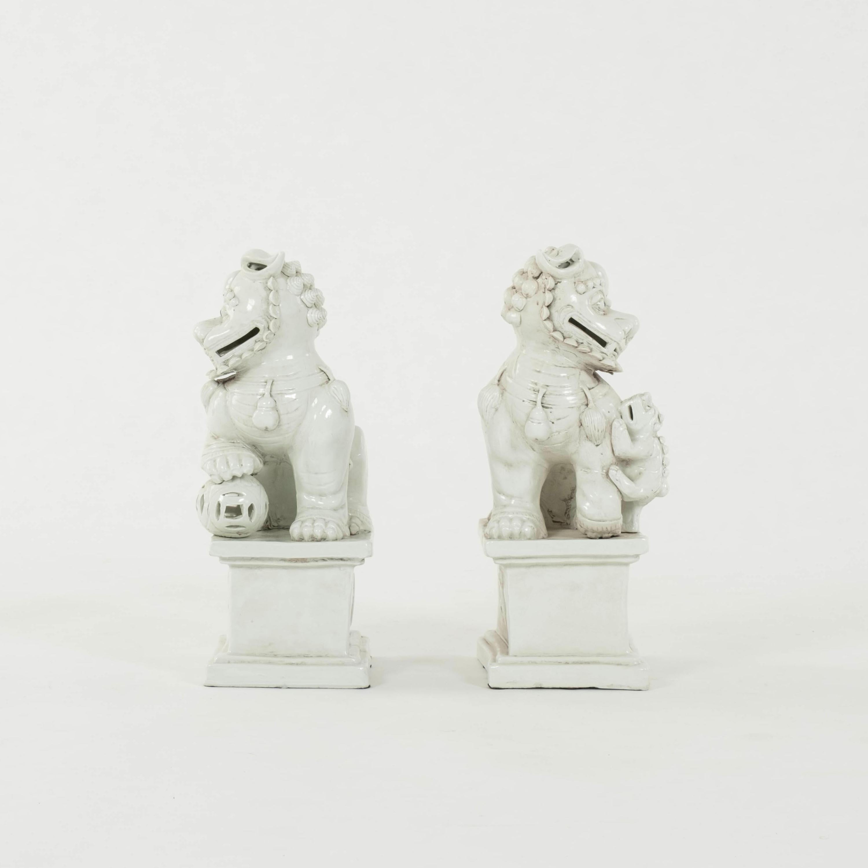 Glazed Pair Sitting Blanc de Chine Fu Dogs For Sale