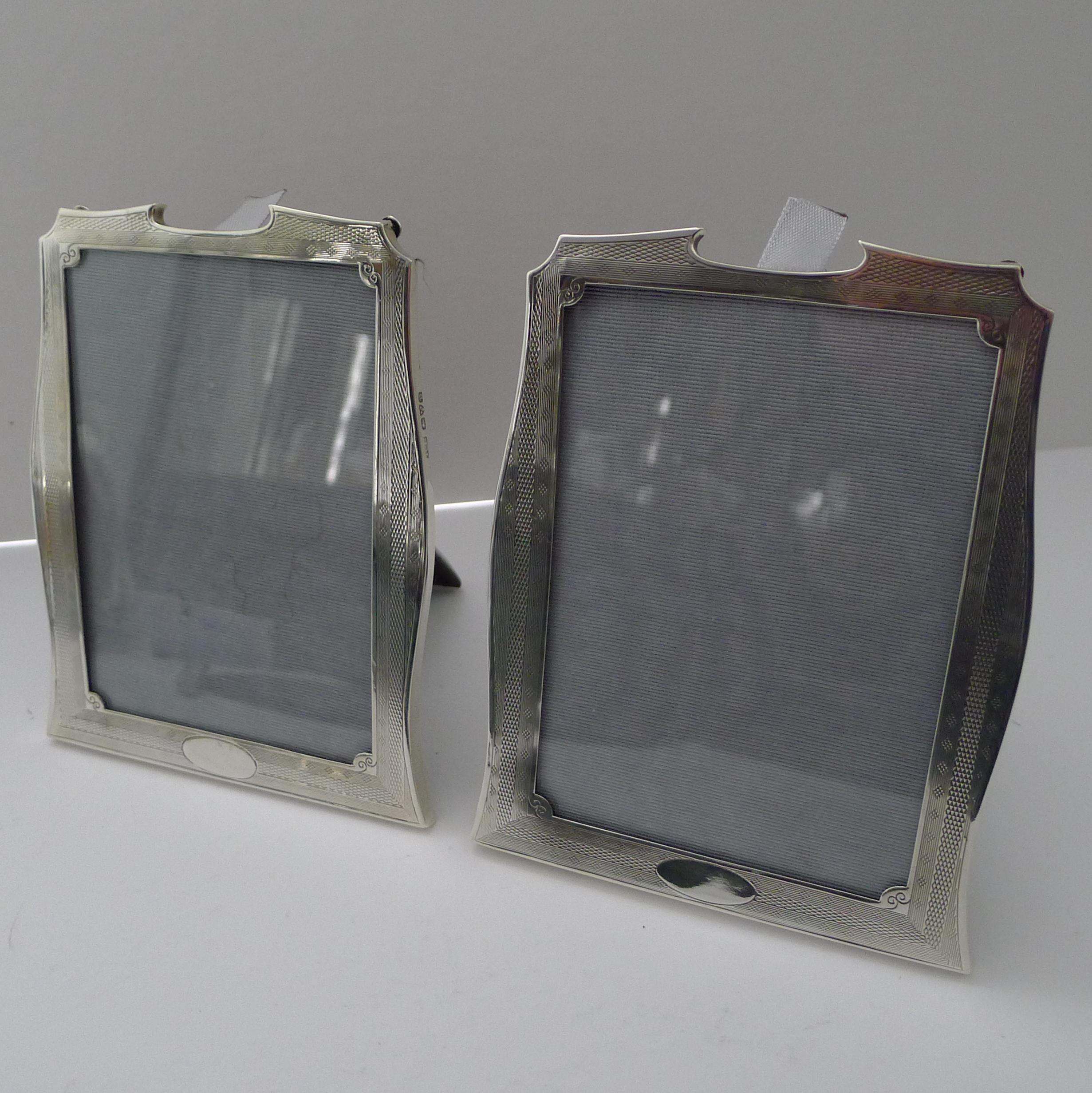 A stylish pair of Art Deco photograph frames decorated with engine turned work. The silver is fully hallmarked for Chester 1929 together with the makers mark for the well renowned silversmith, Robert Pringle & Sons.

The backs are made from solid