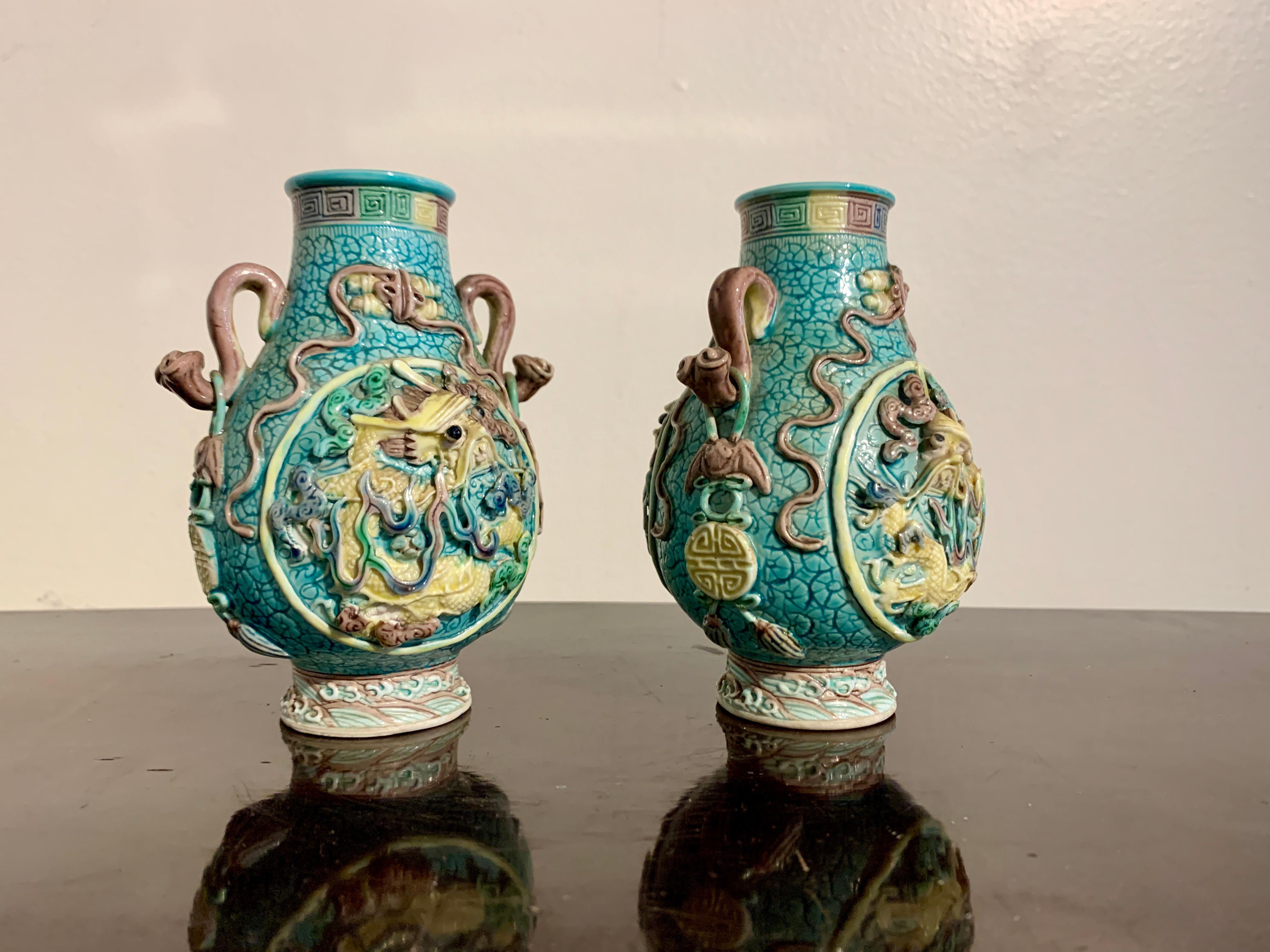 A fabulous pair of small Chinese molded and glazed biscuit ware porcelain dragon vases with loose eyes and apocryphal Qianlong mark, Republic Period, circa 1920, China.

The small vases of traditional 