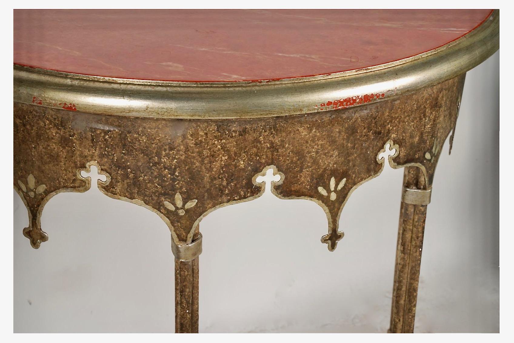 This is a fun pair of petit late 20th century forged iron and faux marble demi-lune consoles. The demi-lunes are beautifully executed in forged iron, tole and faux marble. The iron surfaces have been detailed in patinated gilt work. Both consoles