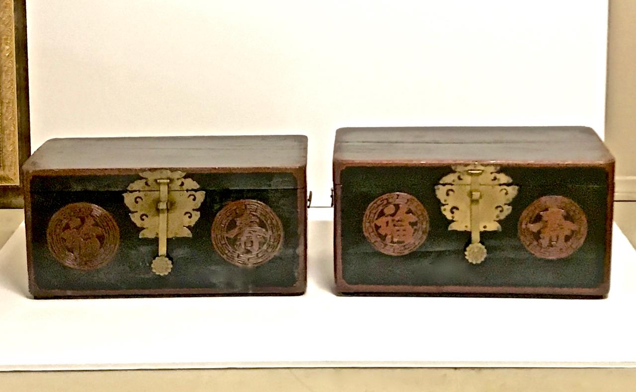 This is a charming near pair of black lacquer small Korean trunks or boxes that date to the end of the 19th century. The trunks are detailed with great butterfly and bat brass fittings. These boxes would be a great accent for shelves or, if mounted