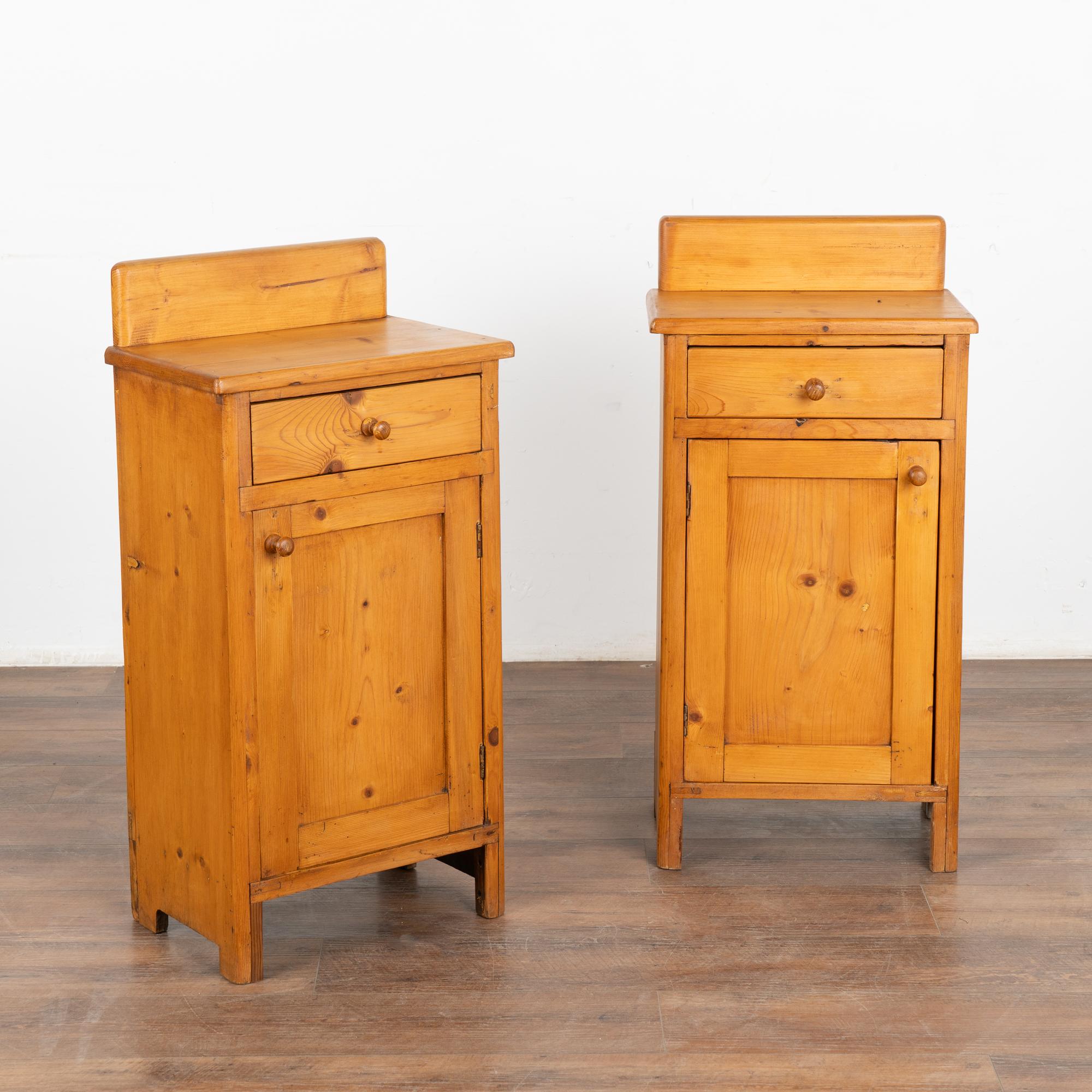 Pair of small pine nightstands, drawer over door with simple backsplash on top.
One nightstand opens to left, the other to right, interior holds one shelf.
Restored, strong, stable and waxed to bring out the natural warmth of the pine. 
Any