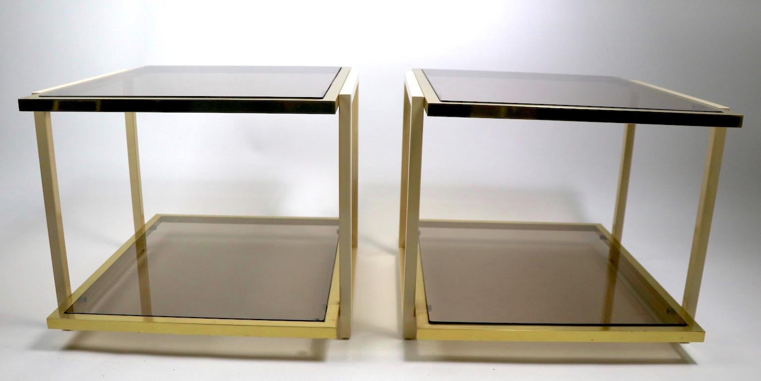 Nice pair of small rectangular tables with brass and cream metal frames, and smoked glass tops (one glass shelf has a minor flaw pictured).
Great style and design, very good original condition, clean ready to use. Design attributed to Tommaso Barbi.
