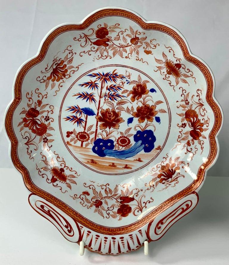 Spode made this pair of fine quality shell-shaped dishes in England in the early 19th century, circa 1820. 
The dishes were printed in shades of orange and blue
 Orange and blue is the traditional color combination of Imari porcelains first exported