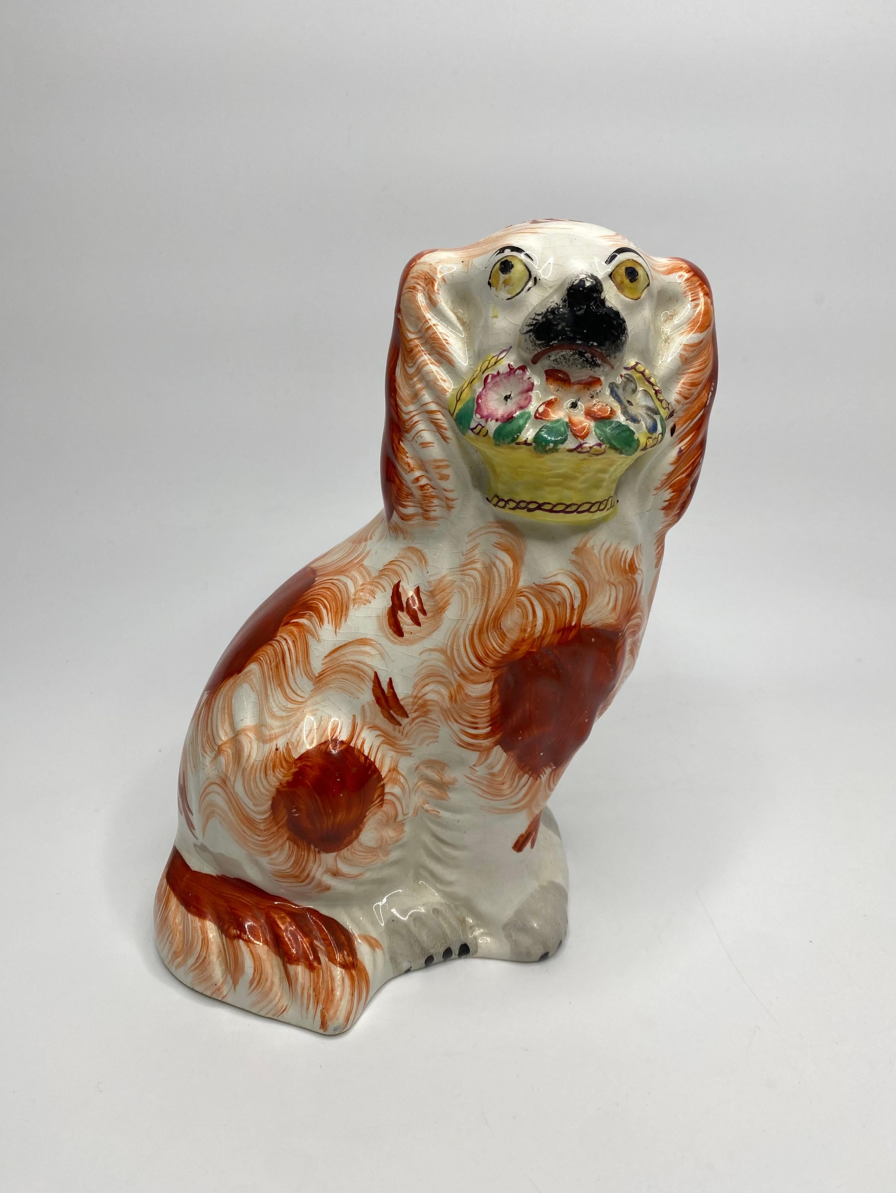 Pair of Staffordshire pottery ‘Basket of Flowers’ Spaniels, c. 1860. Both dogs painted with yellow eyes, and having large liver red spots to their bodies. They carry large, yellow baskets of flowers in their mouths.
Height – 19.5 cm, 7 5/8”.
Width –