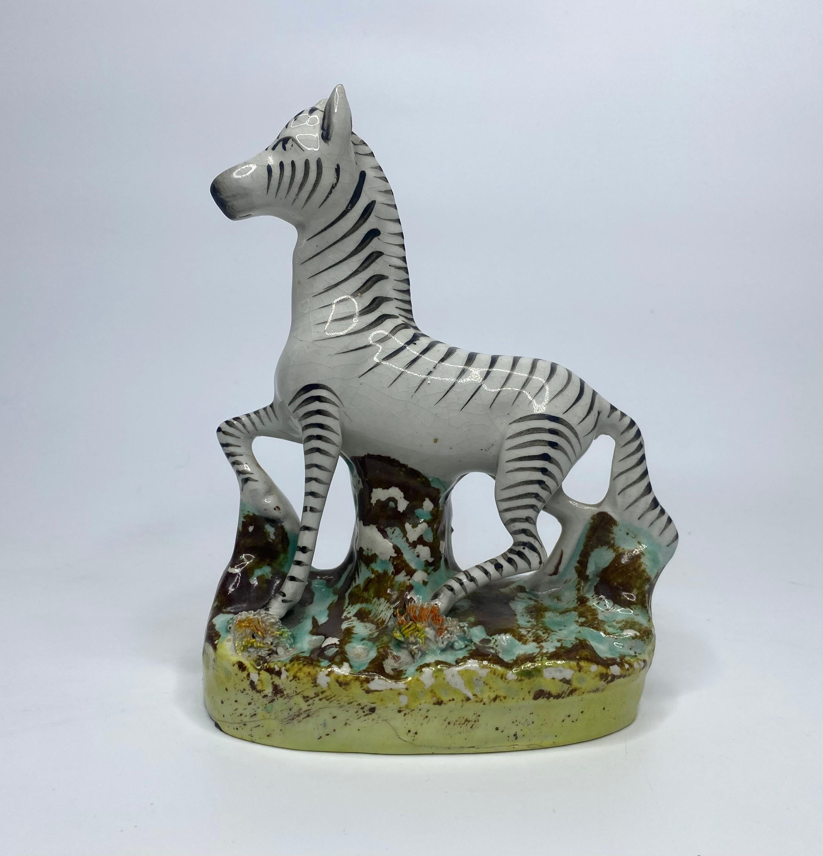 Pair of Staffordshire pottery zebra, Thomas Parr factory, c. 1860. Well modelled as the two zebra, standing upon oval mound grassy bases.
Height – 16 cm, 6 1/4”.
Length – 12 cm, 4 3/4”.
Depth – 6.5 cm, 2 1/2”.
Condition – Glaze crack to reverse of